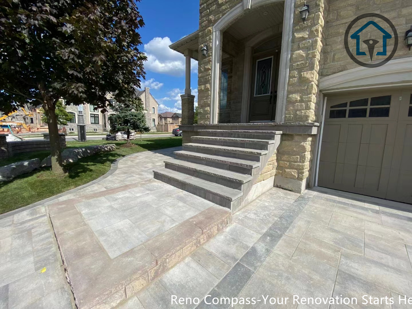 Interlocking patio renovation in Vaughan showcasing smooth transitions between stone surfaces and lawn areas for a cohesive backyard design.