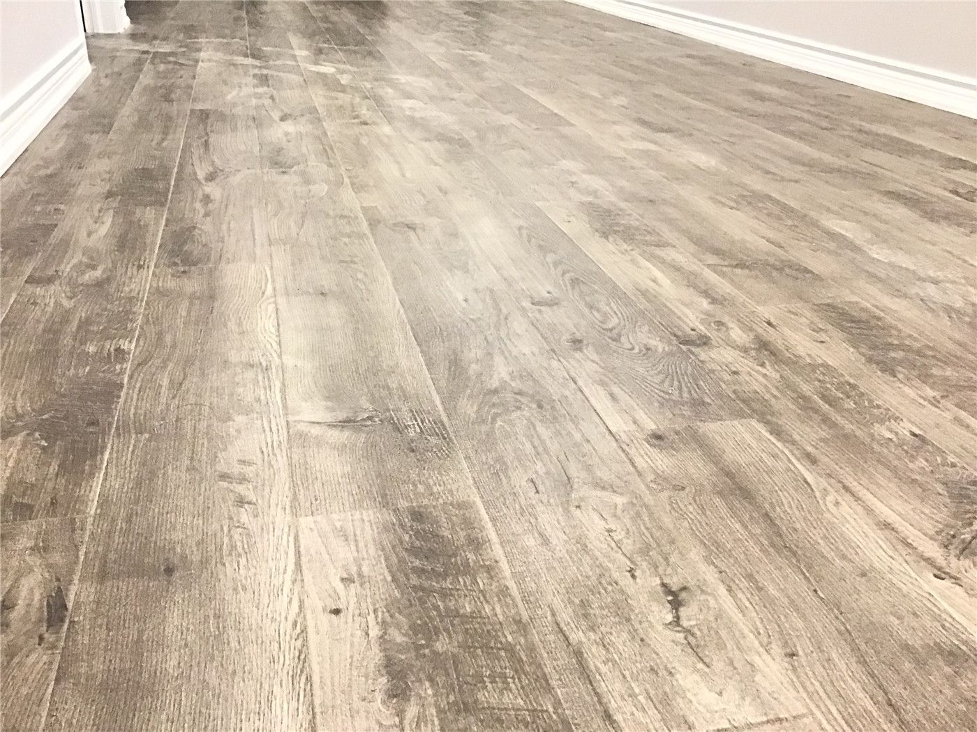 Aurora basement renovation featuring durable luxury vinyl plank flooring with natural wood-grain texture. The waterproof, scratch-resistant finish is ideal for basement spaces, offering both warmth and long-term performance. Installed by an experienced Toronto renovation company to ensure precise alignment, smooth transitions, and a seamless modern look.