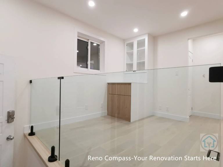 Bright and functional bedroom renovation featuring custom built-in wardrobes, clean white cabinetry, recessed lighting, and light wood flooring. Designed to improve storage efficiency and create a calm, modern living space as part of a full Newmarket interior renovation by Reno Compass Inc.