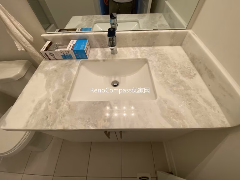 Elegant bathroom renovation featuring a sleek white vanity, marble countertop, large mirror, and LED lighting. Another beautiful Richmond Hill project by Reno Compass.