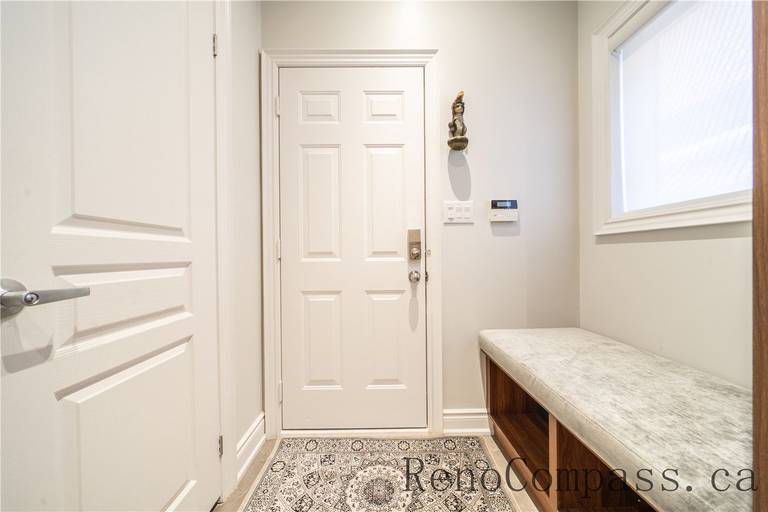 This Richmond Hill entire house interior renovation features a functional mudroom with a custom built-in storage bench, durable flooring, and clean modern finishes. Designed to improve organization and daily convenience, the space offers a practical transition between indoor and outdoor living. Completed by a reliable Toronto renovation company, this mudroom renovation combines smart storage solutions with a clean and timeless interior style.