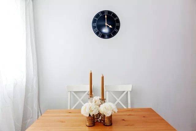 This Toronto interior renovation highlights a simple and elegant dining area featuring clean white walls, natural wood dining furniture, and minimalist décor. The bright space is enhanced by natural light from large windows, creating a calm and inviting atmosphere. The design reflects modern simplicity and functionality, offering a comfortable dining environment for everyday living in a renovated Toronto home.