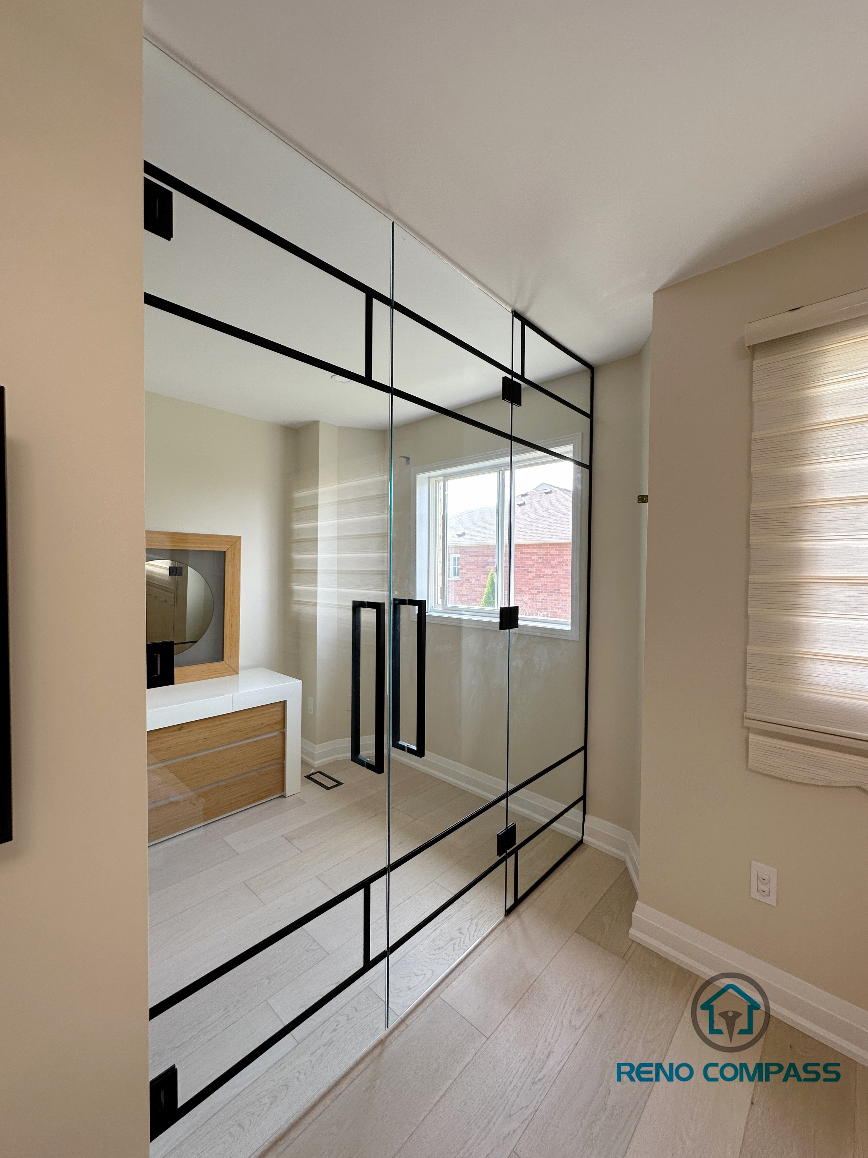 This image features a stunning custom glass door installed in a Vaughan home. The elegant sliding design enhances natural light flow and adds a modern, spacious feel to the interior. Ideal for room dividers or patio access. We provide premium glass door solutions for residential renovations in Vaughan and the GTA.