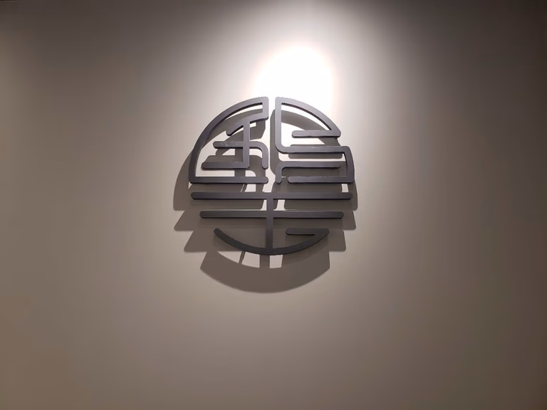 This image showcases a custom wall art feature installed as part of a professional Toronto renovation company commercial interior renovation for a beauty and massage spa. The decorative wall piece is carefully positioned with accent lighting to create a calm, refined, and welcoming atmosphere, enhancing brand identity and customer experience. The design reflects attention to detail, spatial balance, and lighting coordination, which are essential in spa and wellness commercial renovations. Ideal for massage clinics, beauty spas, and wellness centers seeking a modern and tranquil interior upgrade in Toronto.