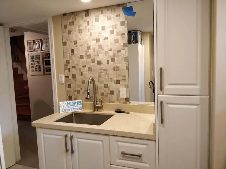 A professional basement transformation by Reno Compass in Scarborough. This project highlights modern space-saving solutions, including a custom wet bar and premium cabinetry installations.