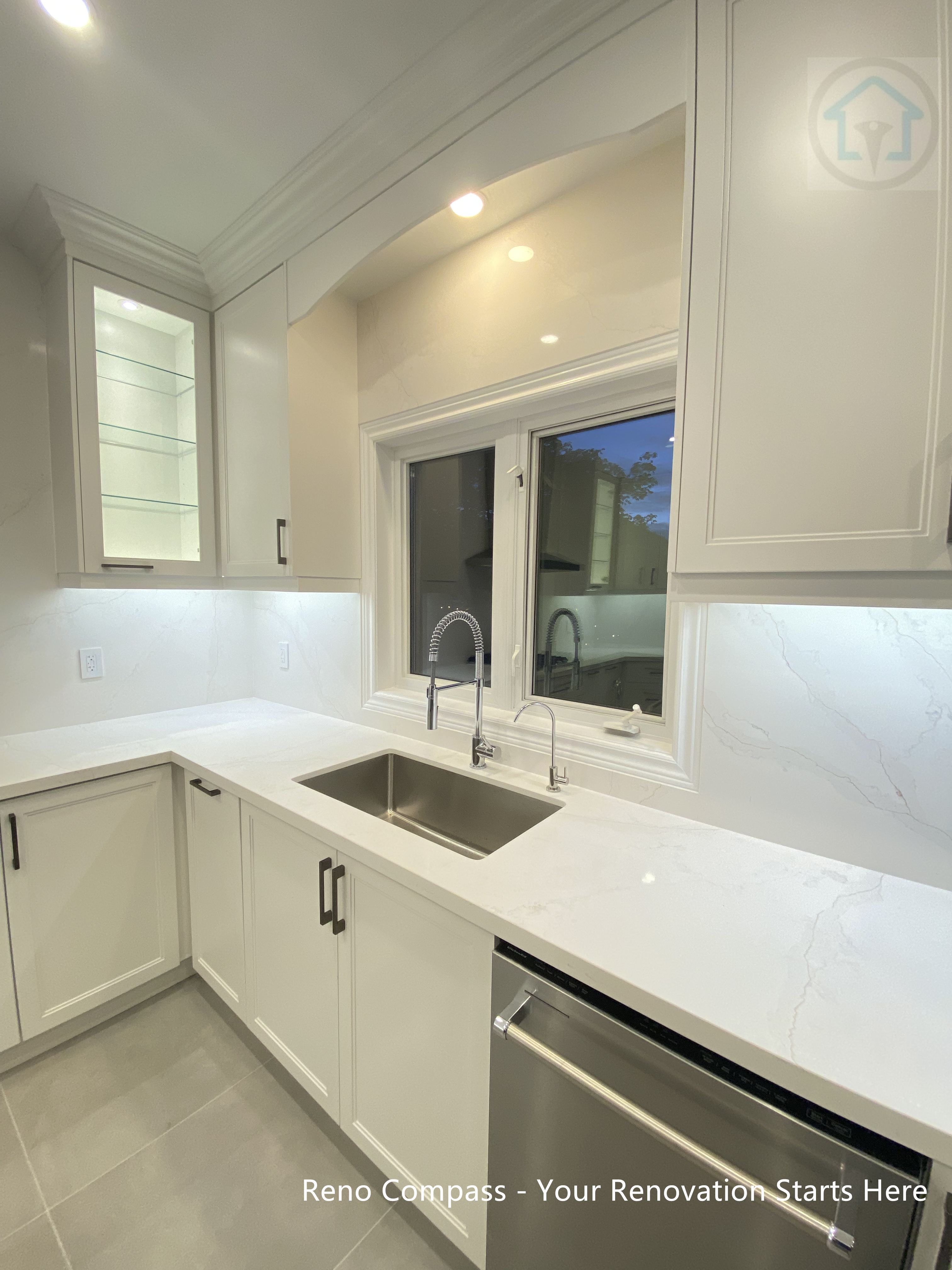 This Oakville kitchen renovation features a clean modern U-shape layout with white custom cabinetry, quartz countertops, undermount stainless steel sink, and integrated LED lighting. Designed to maximize storage, natural light, and daily functionality, this kitchen offers a bright, timeless, and practical cooking space tailored for modern family living. Completed by Reno Compass Inc., a trusted Toronto renovation company serving Oakville and surrounding areas.