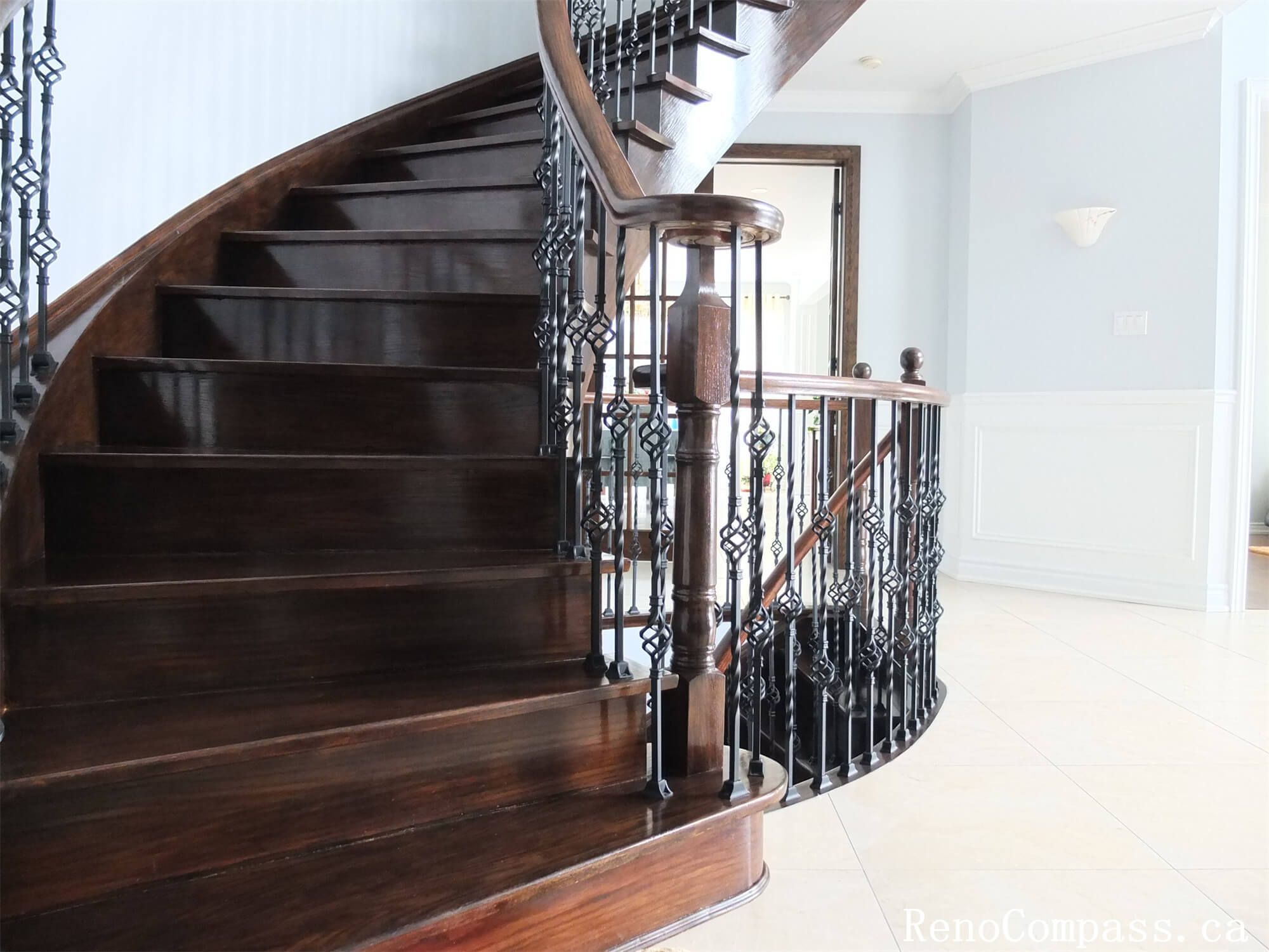 This Richmond Hill interior renovation features a stunning custom curved staircase and grand foyer designed to enhance the home’s architectural elegance. The project includes dark wood stair treads, decorative iron railings, upgraded wall paneling, and modern lighting to create a refined entrance space. The open foyer layout improves visual flow between levels while adding luxury and value to the property. Completed by a trusted Toronto renovation company, this staircase and interior upgrade showcases quality craftsmanship and timeless design for upscale residential living.