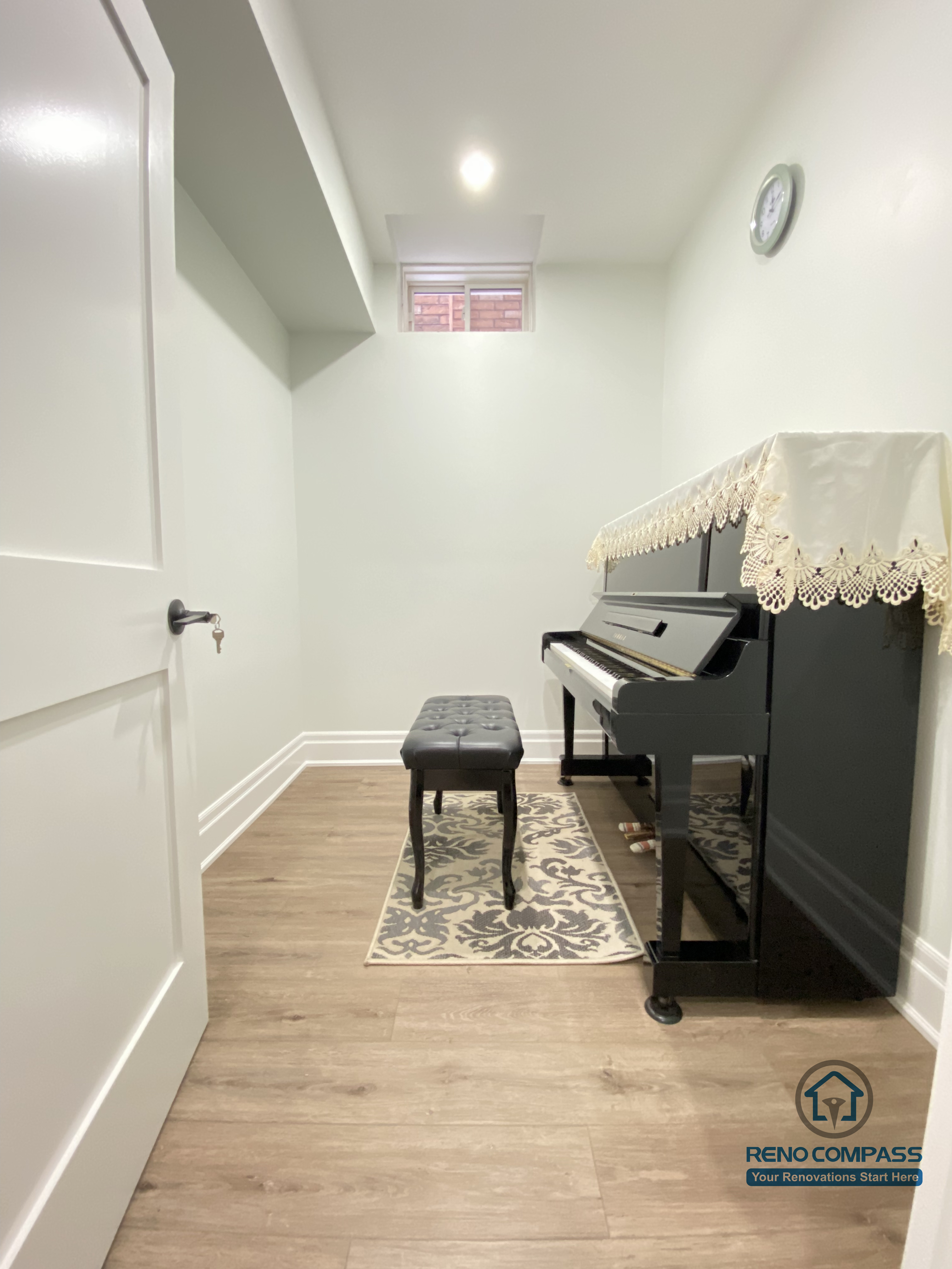 This Oakville basement renovation features a bright, open-concept music room designed for both performance and everyday enjoyment. The space includes premium wood flooring, recessed lighting, and high-set windows to enhance natural light and acoustic balance. A grand piano anchors the room, making it ideal for music practice, private lessons, or refined family entertainment. As a professional Toronto renovation company, Reno Compass focuses on layout optimization, sound-friendly materials, and long-term comfort to create functional yet elegant basement living spaces tailored to homeowners’ lifestyles.