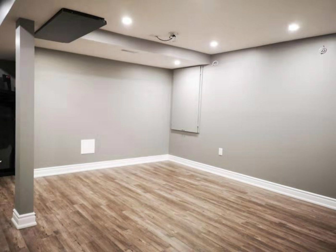 This completed Mississauga basement renovation features modern vinyl plank flooring, recessed pot lights, and a clean open layout. The upgraded space offers improved lighting, durability, and a contemporary aesthetic, demonstrating the quality craftsmanship of a professional Toronto renovation company in transforming basements into functional living areas.