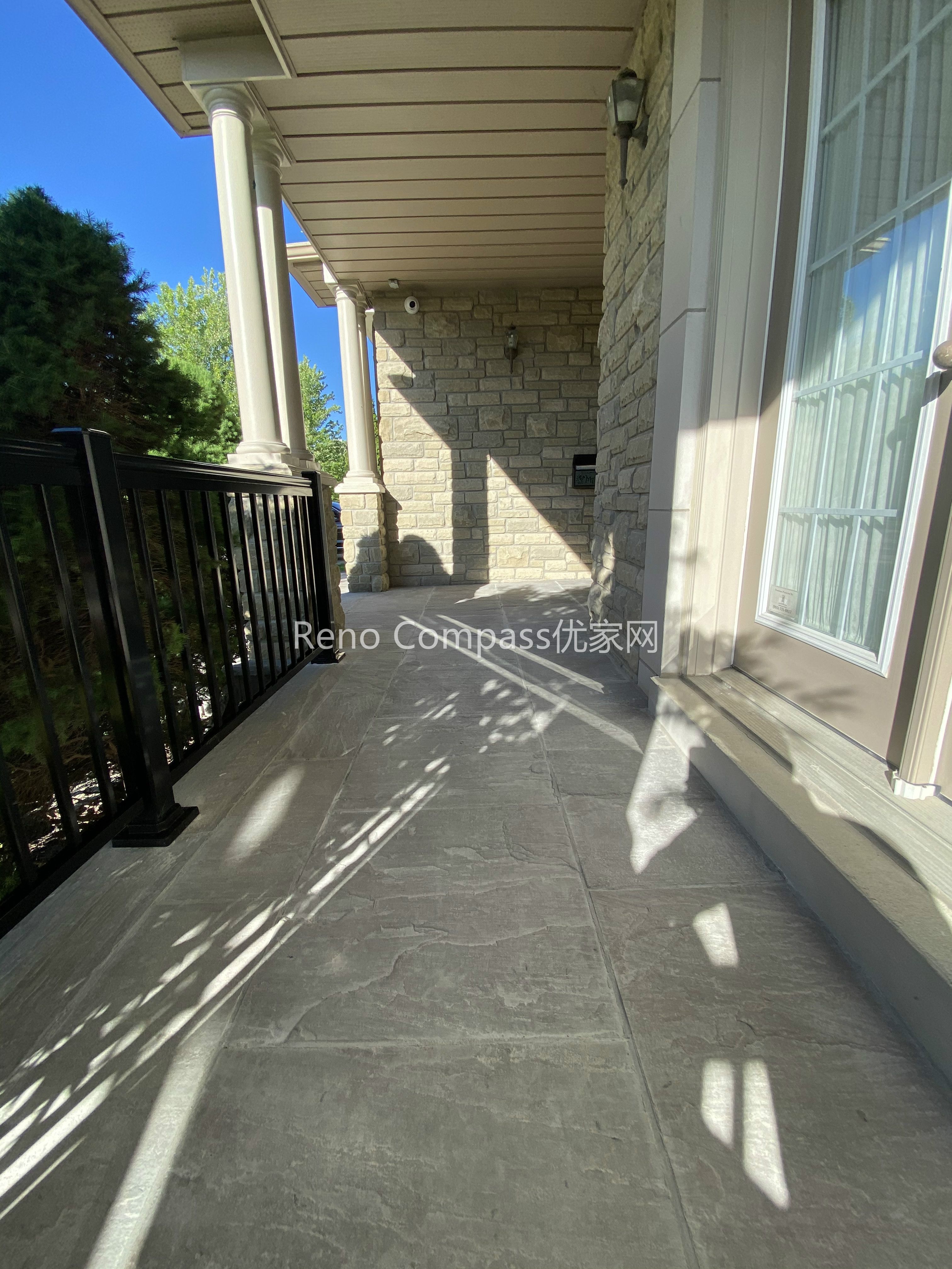 This image features a natural stone interlocking walkway along the side entrance of a North York home. The stone pavers are precisely installed to create a smooth, level walking surface that integrates seamlessly with the home’s stone exterior and metal railing. Proper spacing, alignment, and surface preparation ensure durability, drainage performance, and safe year-round use. Designed as part of a complete driveway interlocking project, this walkway enhances accessibility while maintaining a cohesive outdoor design. Completed by a Toronto interlocking and landscaping contractor, the project demonstrates careful craftsmanship and attention to functional detailing.