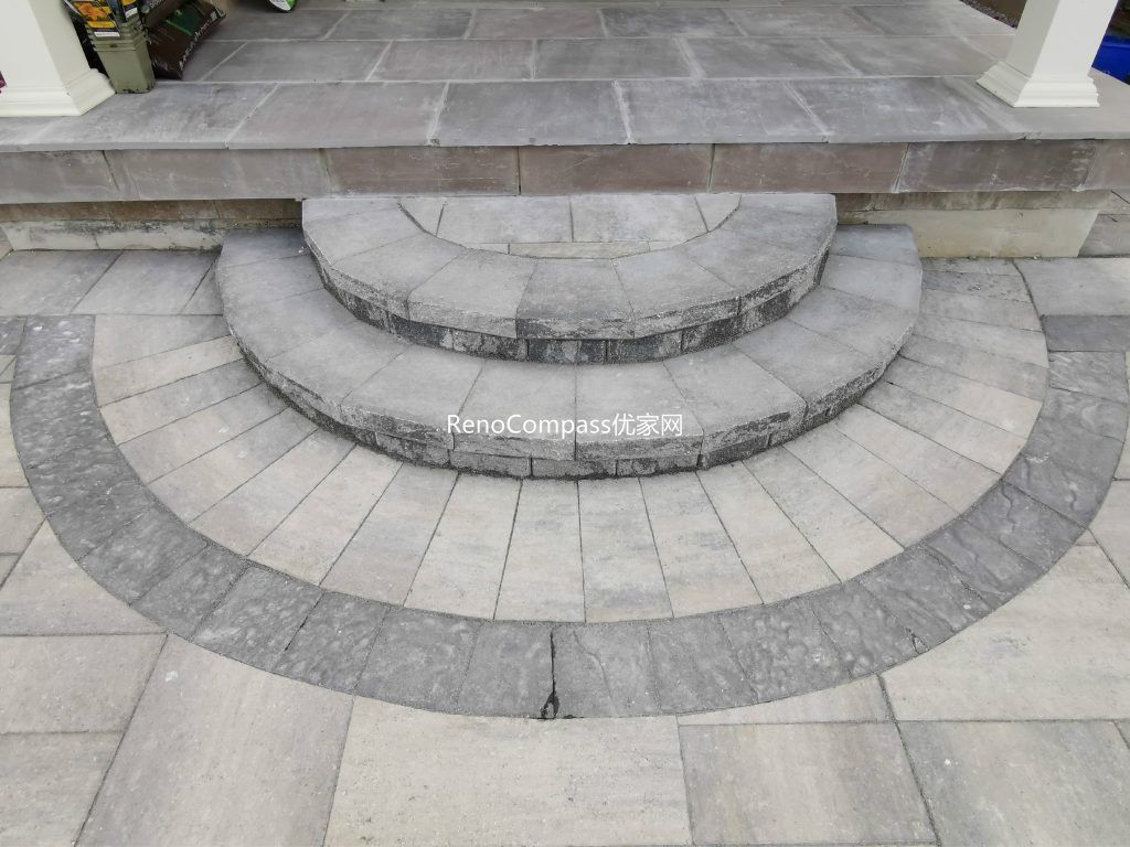 Elegant circular interlocking steps leading to a front porch in Vaughan, designed and installed by Reno Compass. The curved layout and contrasting stone borders highlight expert craftsmanship and timeless curb appeal.