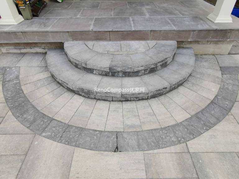 Elegant circular interlocking steps leading to a front porch in Vaughan, designed and installed by Reno Compass. The curved layout and contrasting stone borders highlight expert craftsmanship and timeless curb appeal.