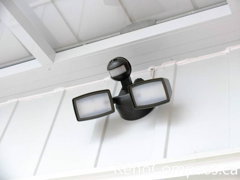 This image highlights the entrance lighting installed at a North York home as part of the front door storm door renovation project. The modern porch light improves nighttime visibility and enhances the safety of the entrance area while complementing the clean white glass vestibule design. Proper exterior lighting also adds warmth and curb appeal to the front entrance. Completed by a professional Toronto renovation team, this upgrade helps create a brighter, more welcoming home entry.