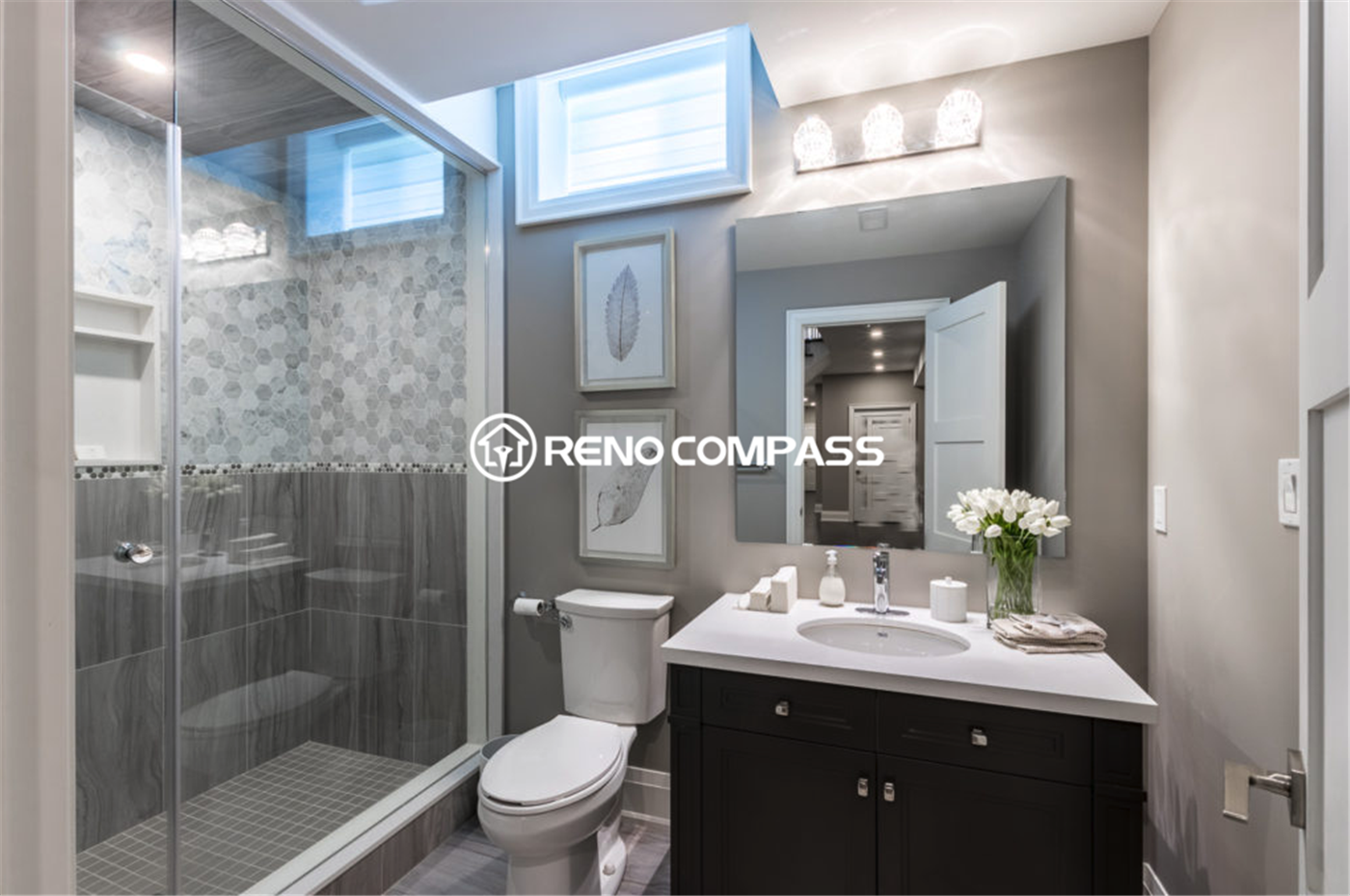 Contemporary basement bathroom renovation in Toronto featuring a sleek glass shower enclosure, modern vanity cabinet, ceramic tile walls, and elegant lighting fixtures. This stylish and functional bathroom upgrade was completed by a professional Toronto renovation company, Reno Compass Inc., enhancing comfort and value for the home.