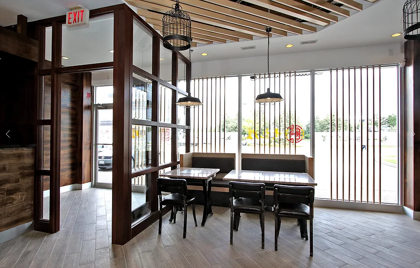 This Markham restaurant renovation by Reno Compass Inc. showcases a bright window seating area designed to enhance natural light and create a comfortable dining atmosphere. Featuring custom wood framing, modern pendant lighting, and durable commercial flooring, the space blends contemporary style with functional layout planning. The upgraded dining zone offers a welcoming environment for guests while supporting efficient restaurant operations and long-lasting performance.