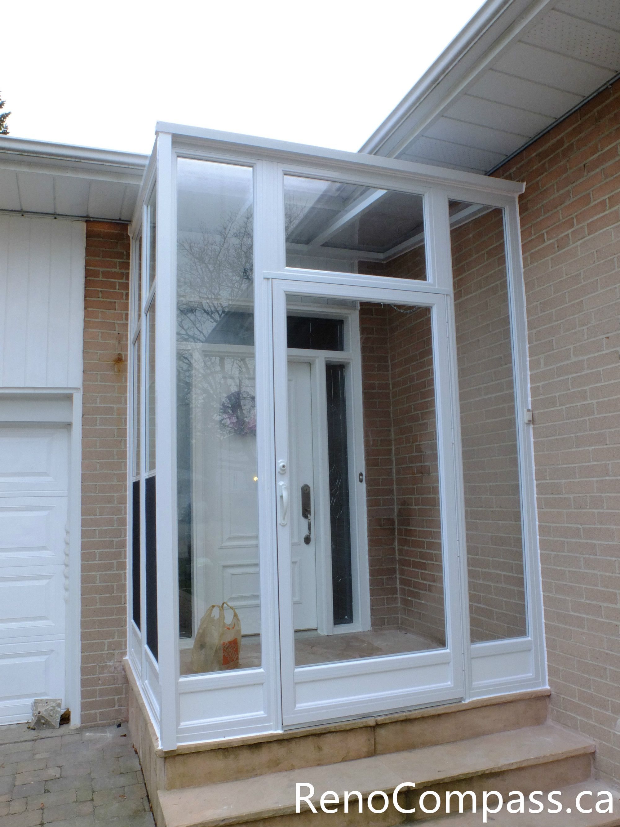 This North York home entrance renovation features a custom glass storm door vestibule designed to improve insulation, weather protection, and curb appeal. The bright white frame and full-height glass panels create a clean, modern look while allowing natural light to enter the entryway. This type of enclosed front entrance helps protect the main door from harsh Canadian weather and improves energy efficiency. Completed by a professional Toronto renovation team, the project enhances both functionality and visual appeal for the homeowner.