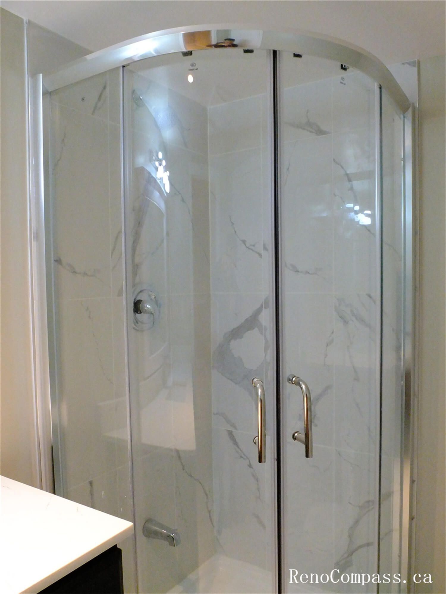 Close-up view of marble-style wall tiles installed in the shower area during this Ajax basement renovation. The large-format tiles with natural grey veining create a clean and elegant bathroom design while providing a durable, moisture-resistant surface ideal for shower spaces. Completed by a professional Toronto Renovation Company, this tile installation enhances both the modern aesthetic and long-term functionality of the basement bathroom.