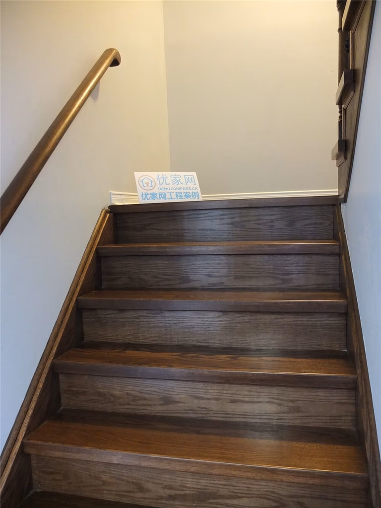 This image features a completed hardwood staircase renovation in a Mississauga home, showcasing solid wood stair treads with a smooth finish and rich natural tones. The upgraded staircase creates a clean and elegant vertical transition between floors while matching the surrounding hardwood flooring. As a professional Toronto Renovation Company, Reno Compass delivers high-quality staircase and flooring renovations that improve both the aesthetic value and durability of residential interiors.