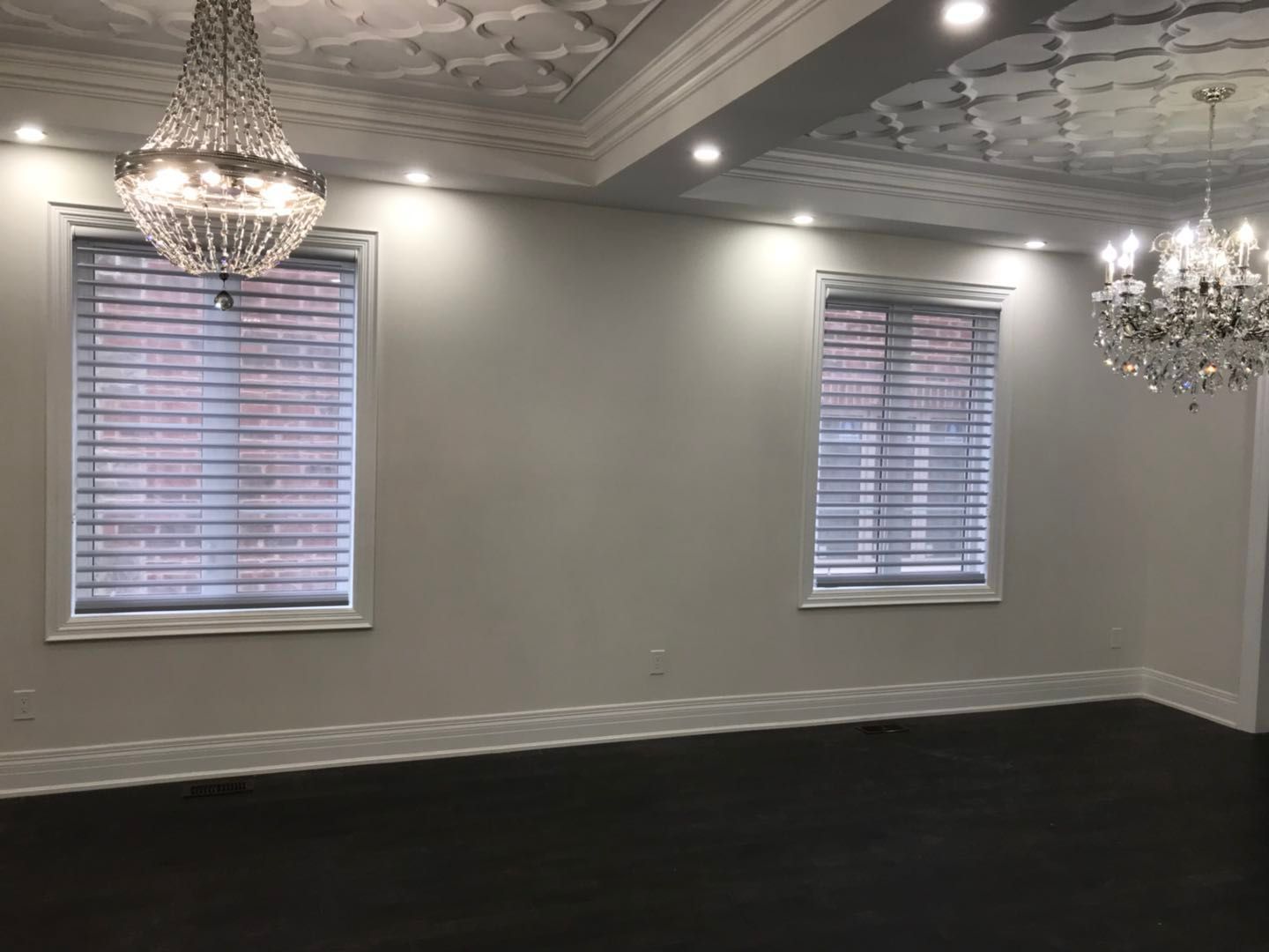 Custom zebra blinds installation in Toronto dining room by professional Toronto renovation company Reno Compass Inc. Featuring dual-layer light filtering shades, clean white window trim, modern chandelier lighting, and elegant wall panel detailing. This window treatment upgrade enhances privacy, natural light control, and interior aesthetics with a sleek and contemporary finish.