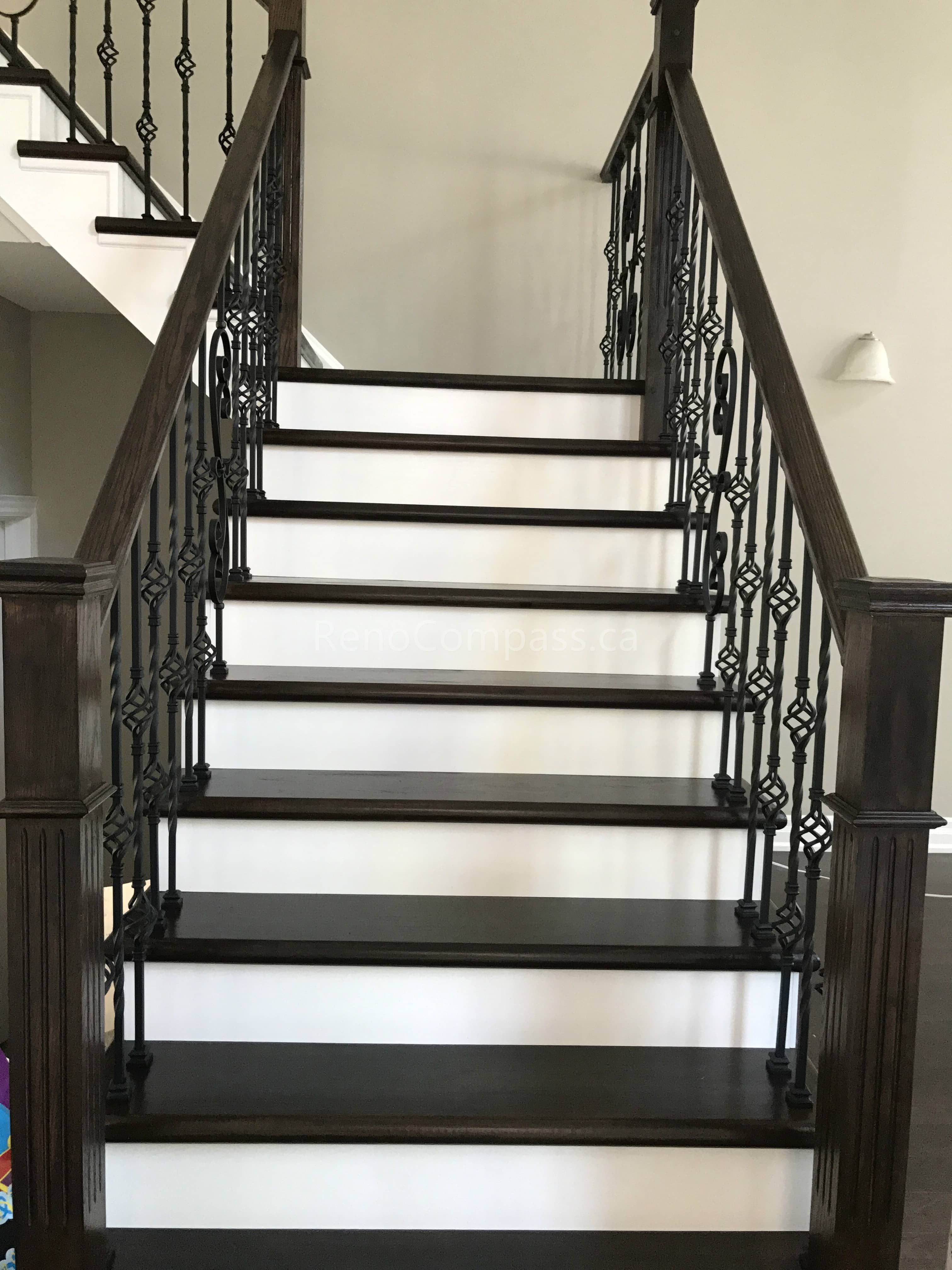 This Markham home renovation features a beautifully upgraded hardwood staircase with dark wood stair treads and elegant wrought iron railings. The contrast between the rich flooring and bright risers creates a clean, modern, and sophisticated visual impact. Completed by a trusted Toronto renovation company, this staircase upgrade enhances both safety and interior aesthetics while maintaining a cohesive flooring design throughout the home.