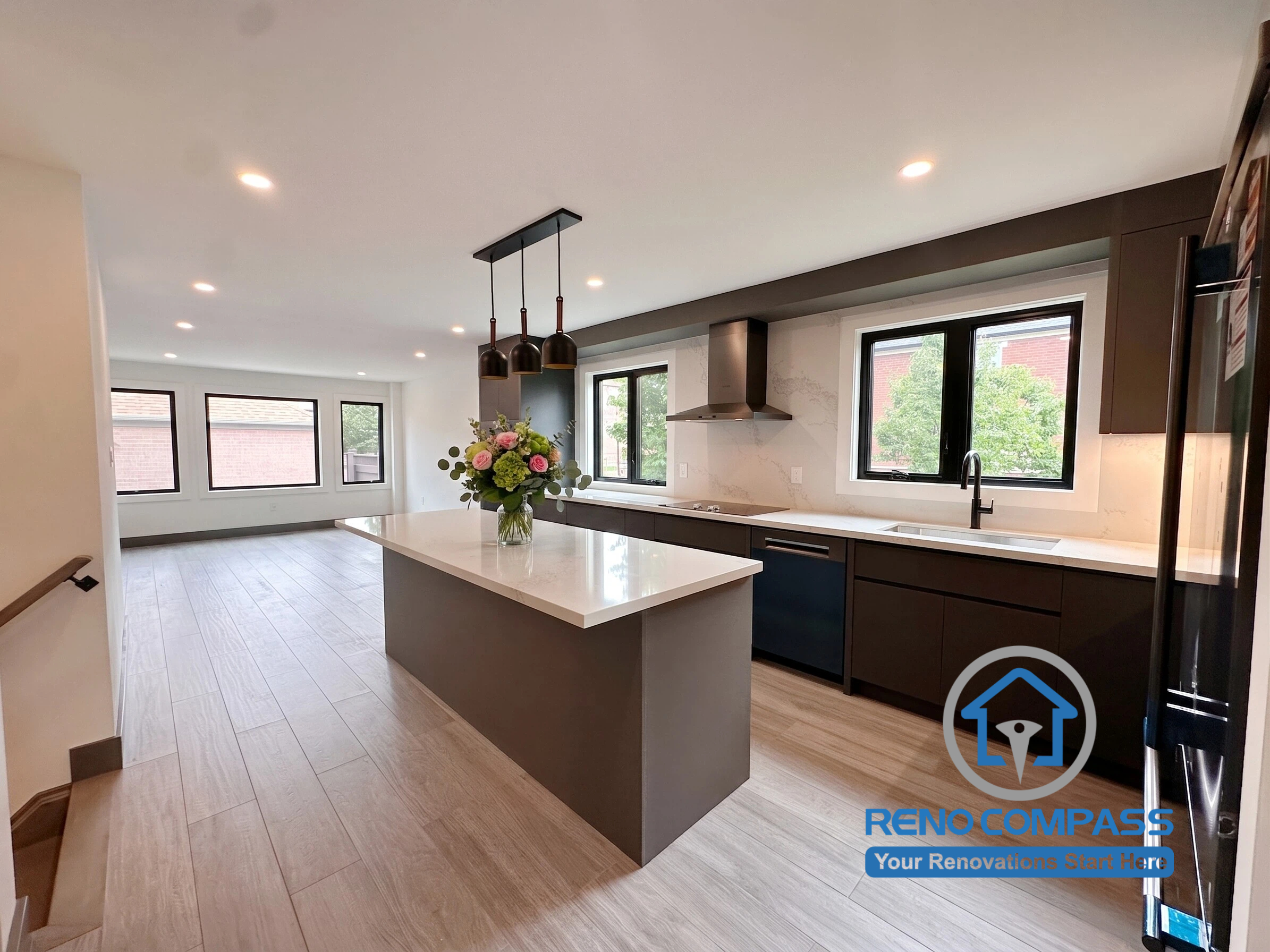 This open-concept kitchen renovation features a spacious custom island, quartz countertops, and modern cabinetry designed to enhance everyday living. By removing interior partition walls, the home now offers improved natural light, better flow, and seamless connectivity between the kitchen, dining, and living areas. Project completed by Reno Compass, serving Markham, Toronto, Richmond Hill, Vaughan, and the Greater Toronto Area.