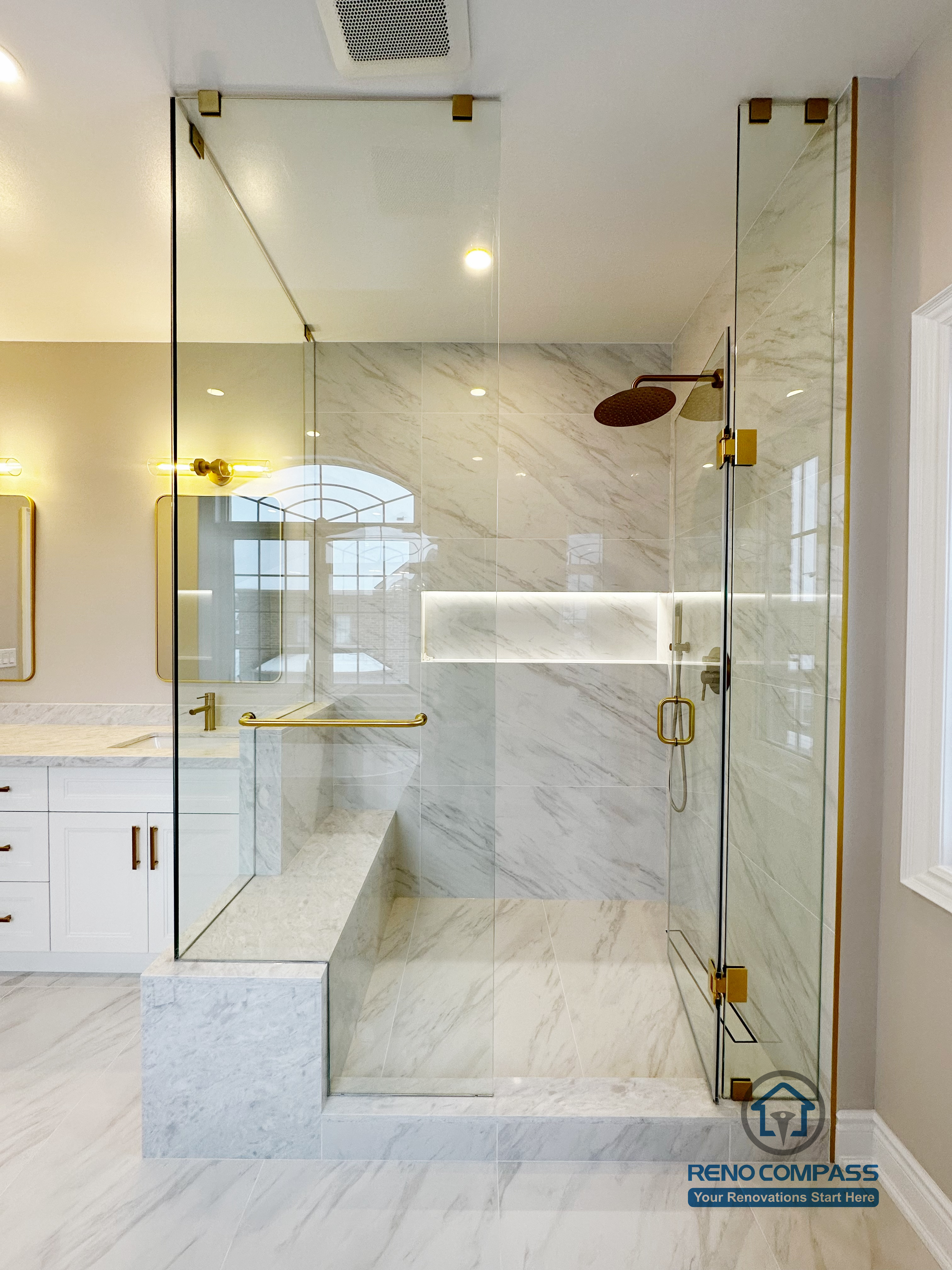 Full view of a Vaughan primary bathroom renovation showcasing a custom double vanity with quartz countertop, gold fixtures, LED mirror lighting, and a frameless glass walk-in shower finished with marble-look porcelain tile. The layout maximizes light, storage, and circulation, completed by a professional Toronto renovation company specializing in high-end bathroom design.