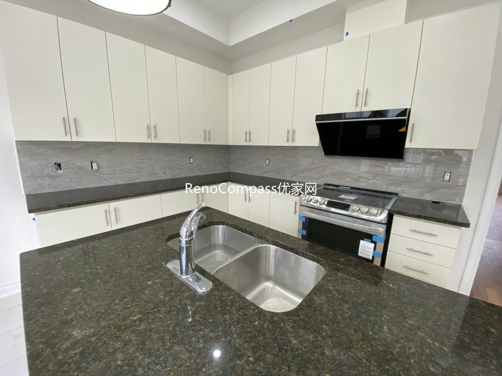 Custom-designed basement bar area renovation in Richmond Hill featuring a modern countertop, efficient lighting, and open-space layout. Reno Compass enhanced functionality and aesthetic appeal for entertainment use.