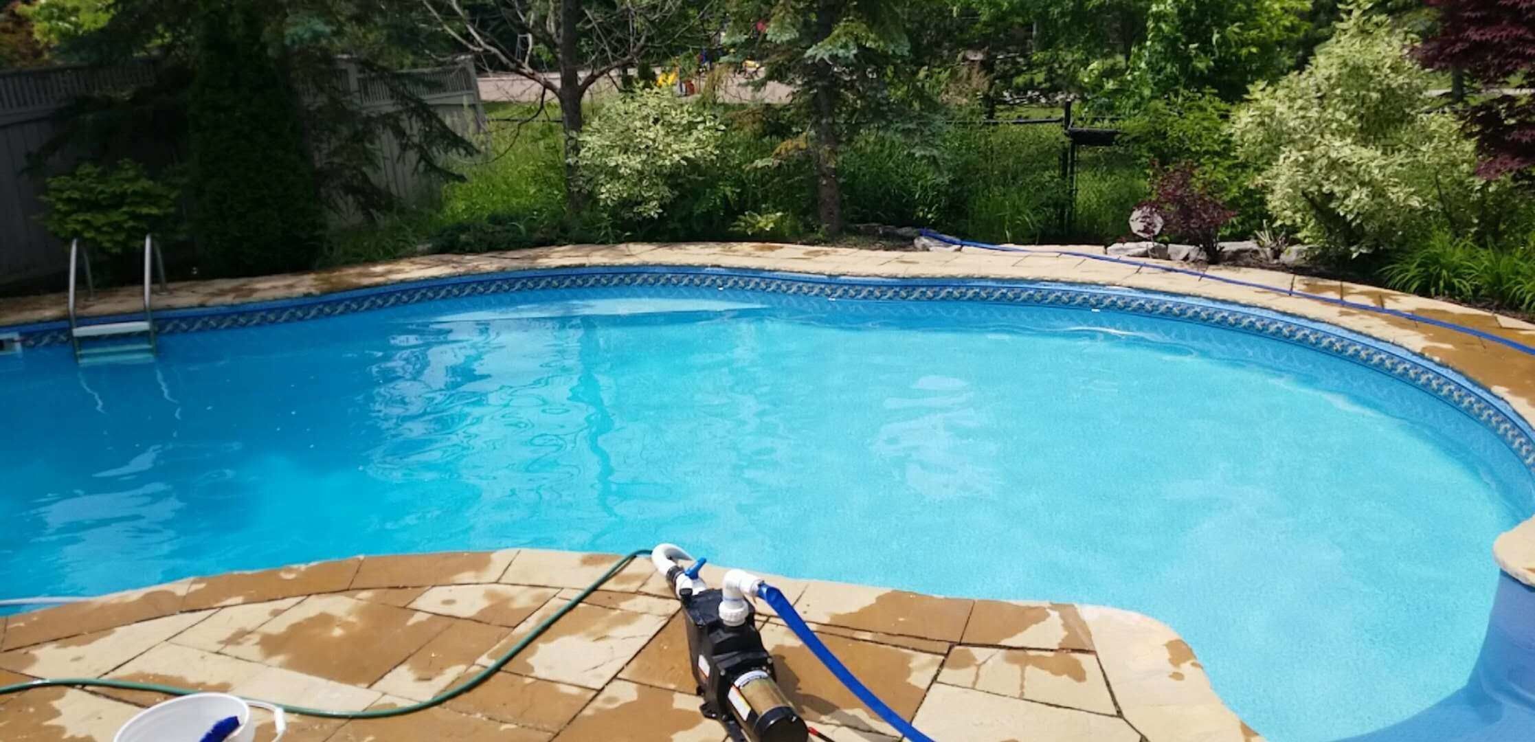After renovation photo of a fully restored backyard swimming pool in Toronto. The new bright blue liner, clean water, and resurfaced edges highlight the professional pool transformation from old and damaged to modern and inviting. Expert pool renovation by local Toronto specialists.