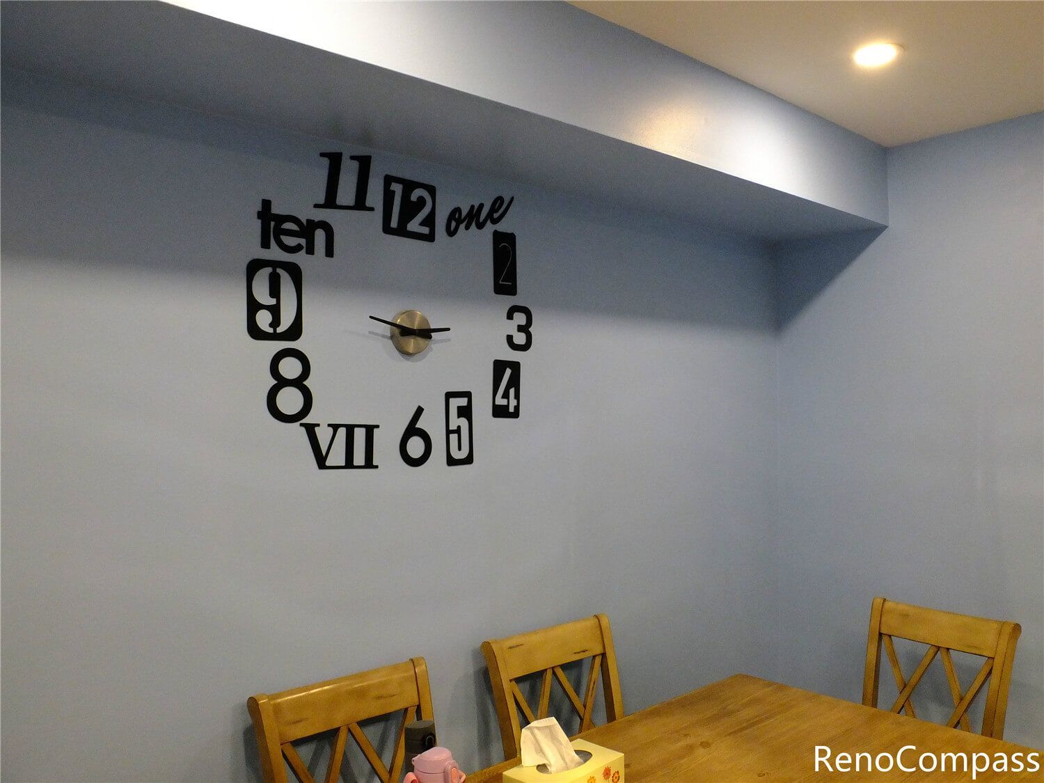 This Aurora kitchen renovation also included improvements to the dining area, featuring a clean painted wall, modern recessed lighting, and a decorative wall clock that adds character to the space. The open layout connects the kitchen and dining area seamlessly, creating a comfortable environment for everyday meals and family gatherings. The renovation focuses on simple, functional design with bright finishes and practical lighting, completed by Reno Compass Inc., a trusted Toronto renovation company serving Aurora and the GTA.