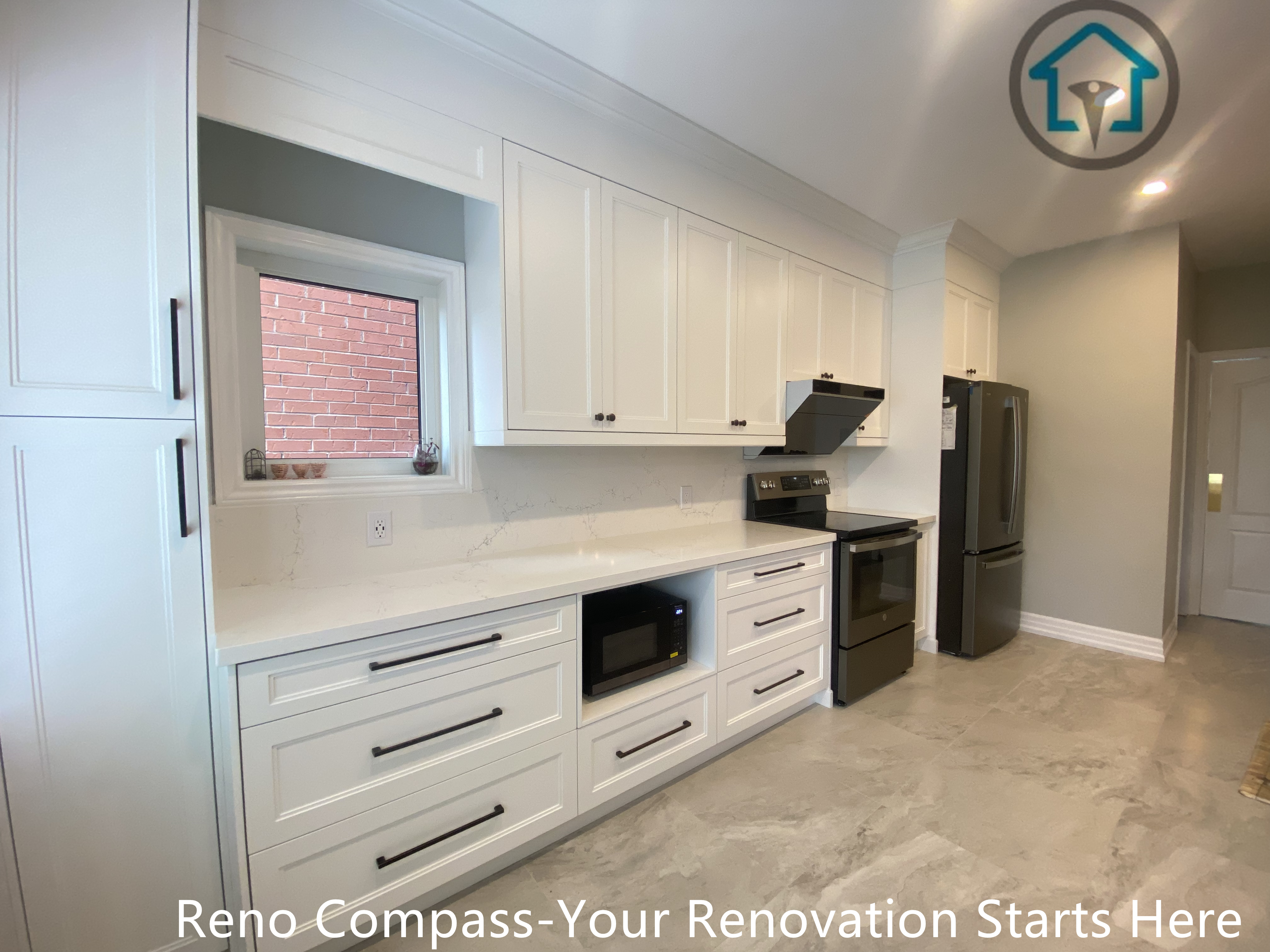 This image highlights the main working wall of the Markham kitchen renovation, featuring full-height white cabinetry designed to maximize storage and maintain a clean, cohesive look.