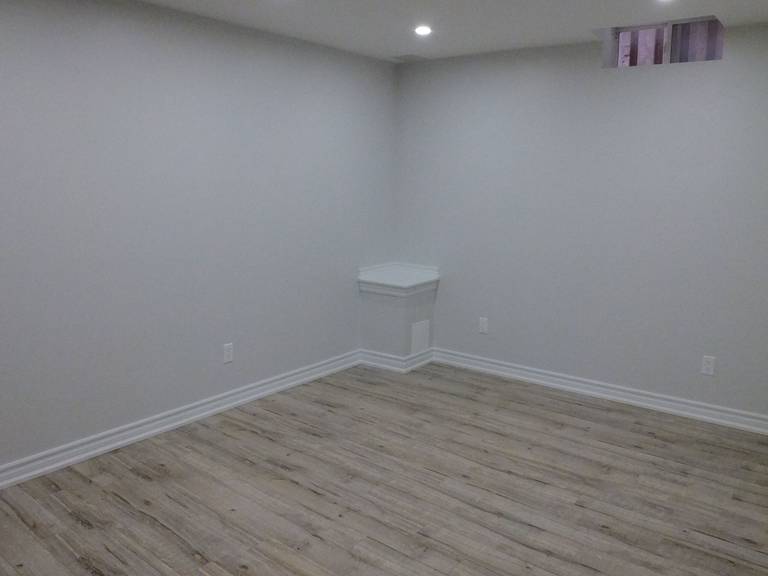 This image shows the finished basement flooring and wall finishes completed as part of a Richmond Hill basement renovation. Light-colored walls and durable flooring materials improve brightness and usability, transforming the basement into a functional living space. Completed by a professional Toronto renovation company, this upgrade enhances comfort and long-term durability.