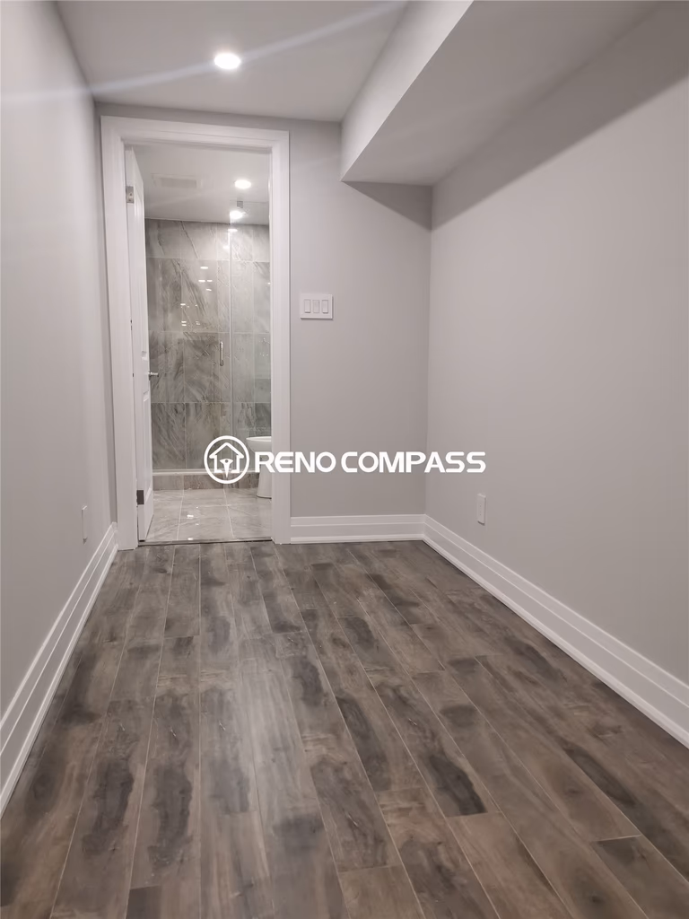 This Markham basement renovation project showcases newly installed waterproof vinyl flooring, modern recessed pot lights, and a clean hallway leading to a fully upgraded bathroom. The space was redesigned to improve durability, brightness, and everyday functionality, creating a comfortable and low-maintenance basement environment. Completed by a professional Toronto renovation company, the project highlights quality flooring installation, precise finishing, and modern basement remodeling tailored for long-term residential use in the Greater Toronto Area.