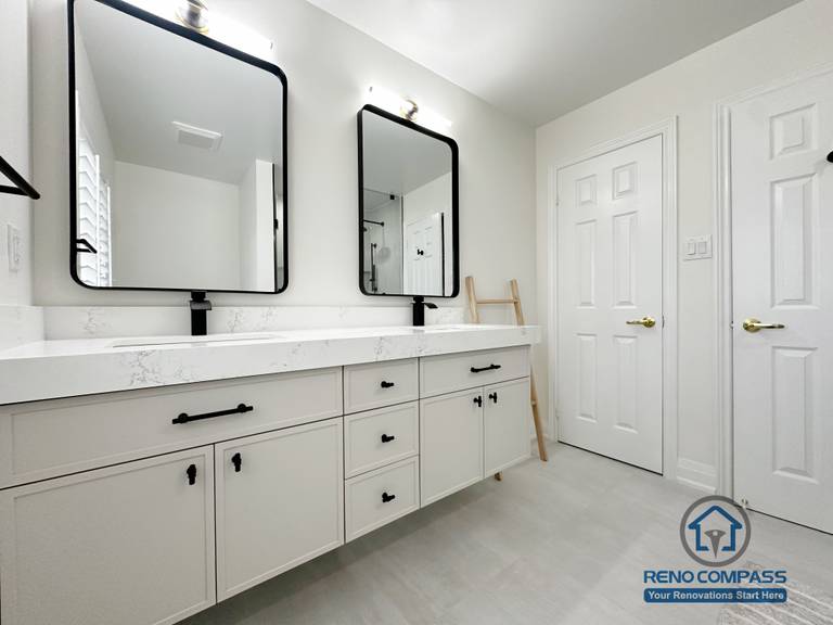 This Markham bathroom renovation features a clean double vanity layout with custom cabinetry, quartz countertops, and matte black fixtures. Dual framed mirrors and balanced lighting enhance functionality while maintaining a calm, modern aesthetic. Designed for daily comfort, storage efficiency, and long-term durability.