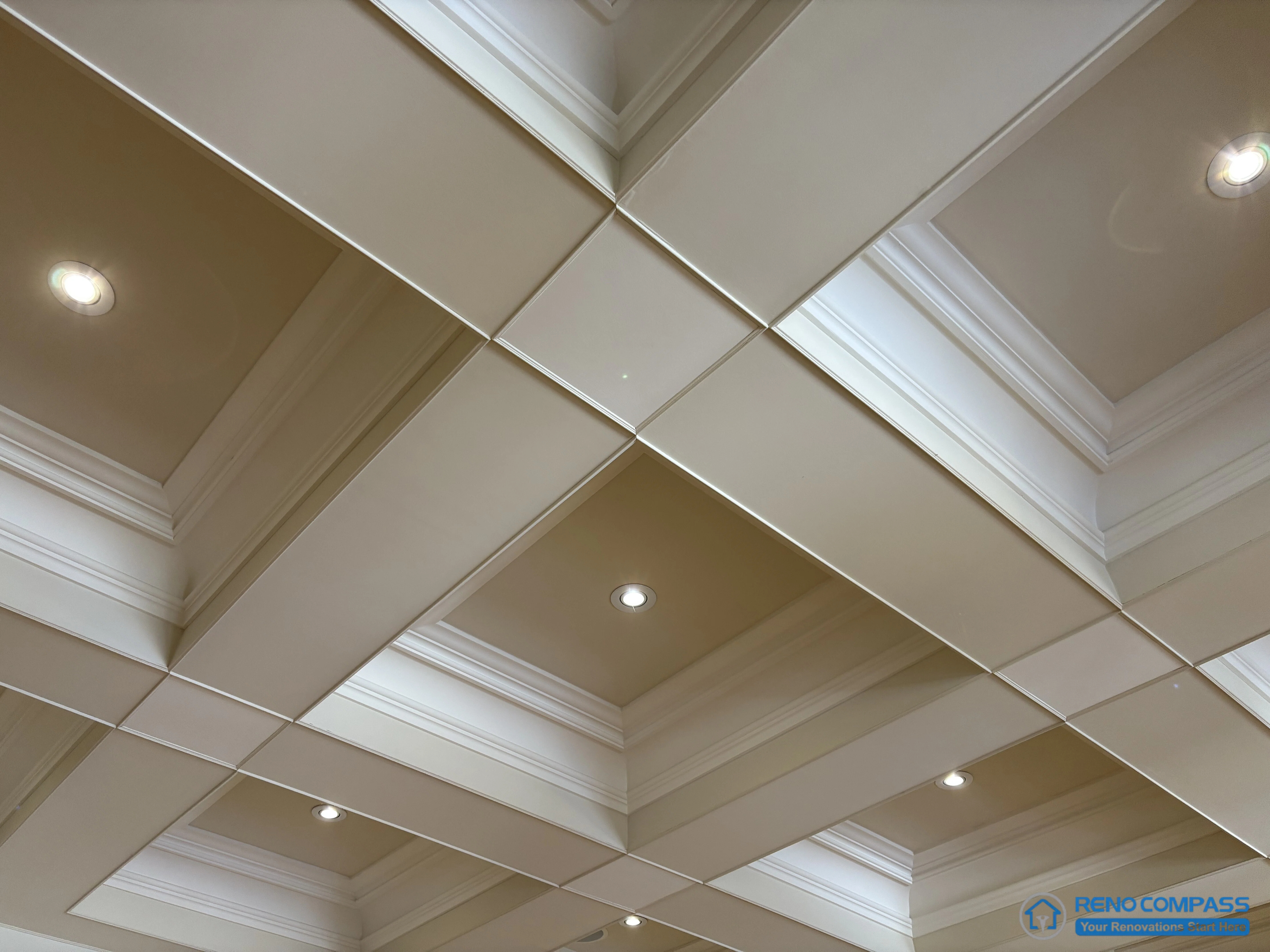 This image highlights a European-style coffered ceiling featuring layered classical moulding and precisely aligned ceiling panels. The structured grid establishes clear rhythm and proportion, while recessed lighting is integrated discreetly within the ceiling composition. The detailing emphasizes craftsmanship and architectural order rather than surface decoration, reinforcing the ceiling’s role as a defining structural element. This view showcases refined ceiling construction within a high-end Richmond Hill interior renovation rooted in traditional European architectural principles.