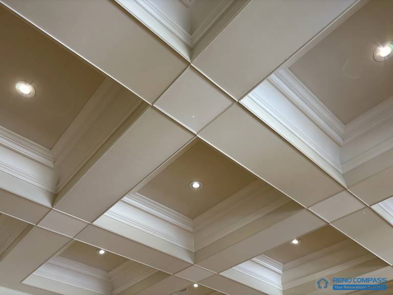 This image highlights a European-style coffered ceiling featuring layered classical moulding and precisely aligned ceiling panels. The structured grid establishes clear rhythm and proportion, while recessed lighting is integrated discreetly within the ceiling composition. The detailing emphasizes craftsmanship and architectural order rather than surface decoration, reinforcing the ceiling’s role as a defining structural element. This view showcases refined ceiling construction within a high-end Richmond Hill interior renovation rooted in traditional European architectural principles.