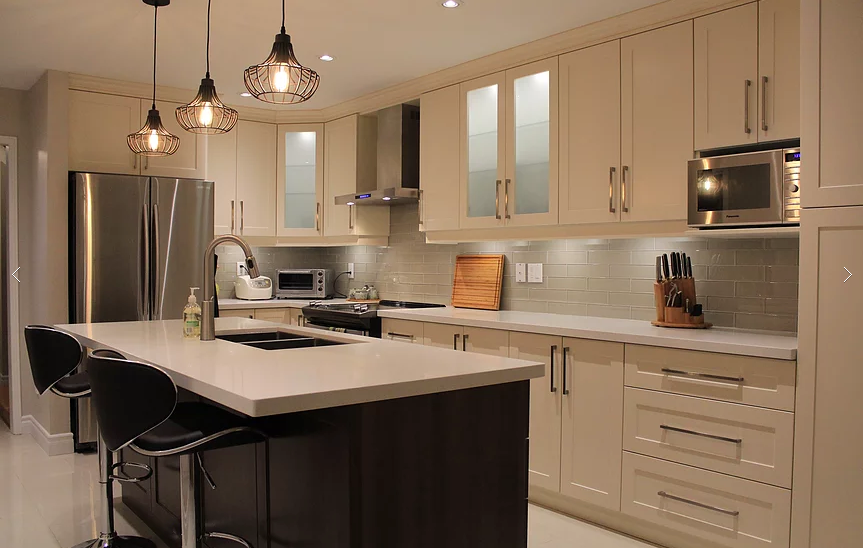 This Mississauga kitchen renovation features custom cream cabinetry, a large quartz island, modern pendant lighting, and upgraded backsplash design. Completed by a professional Toronto renovation company, the project focuses on improving functionality, storage, and modern aesthetics. The spacious island with built-in sink and seating enhances daily use and entertaining, while new lighting and finishes create a warm, elegant atmosphere. Ideal for homeowners in Mississauga seeking a stylish and practical kitchen upgrade with high-quality craftsmanship and thoughtful layout planning.