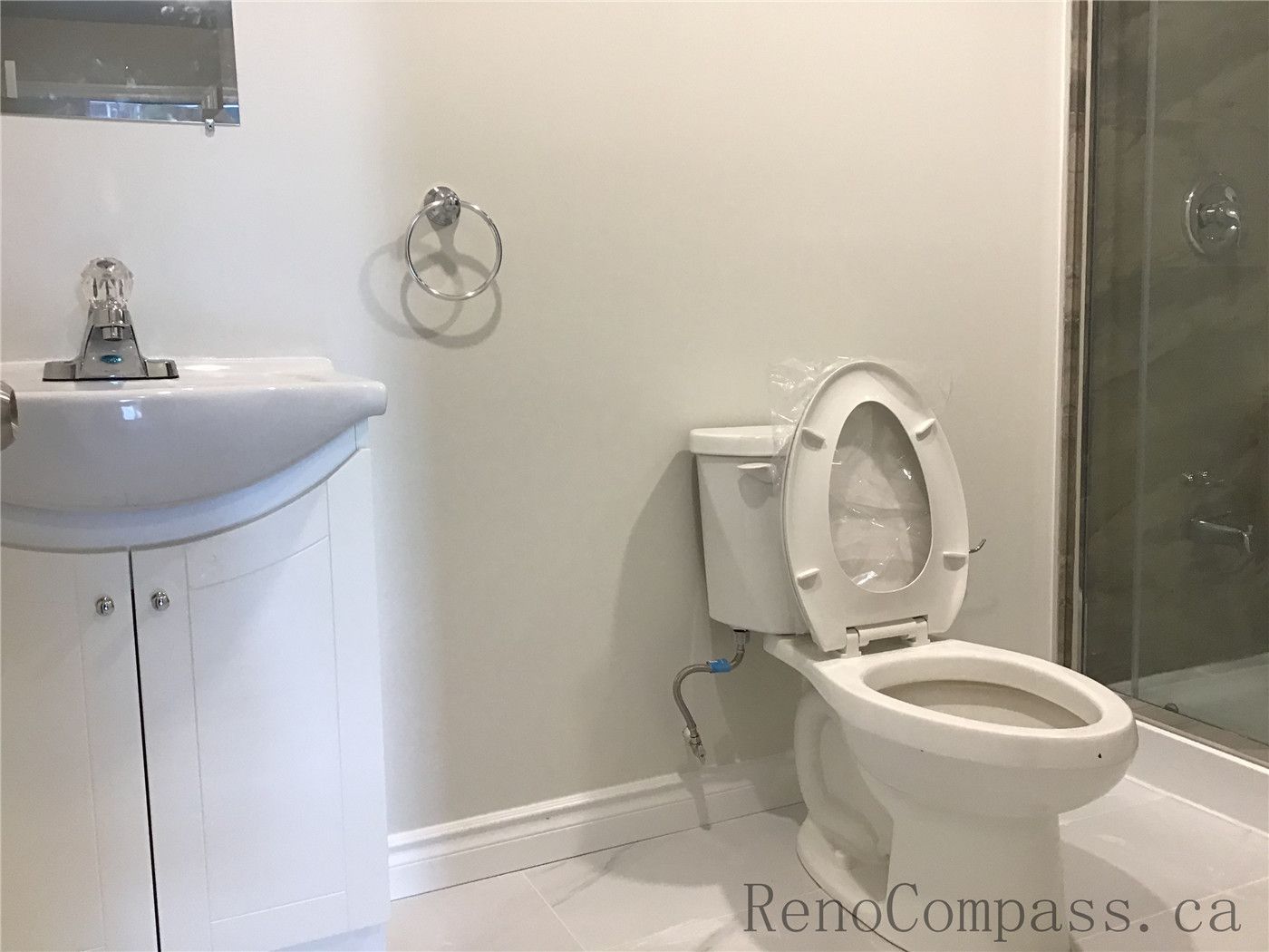 As part of this Whitby basement renovation, a clean and functional bathroom was installed featuring a space-efficient vanity, modern toilet, and a glass-enclosed shower. Neutral wall tones and light floor tiles create a bright, low-maintenance environment, while chrome fixtures add a subtle contemporary touch. This upgraded basement bathroom enhances both convenience and overall property value.

Upload the next image and I’ll continue completing the full project set.