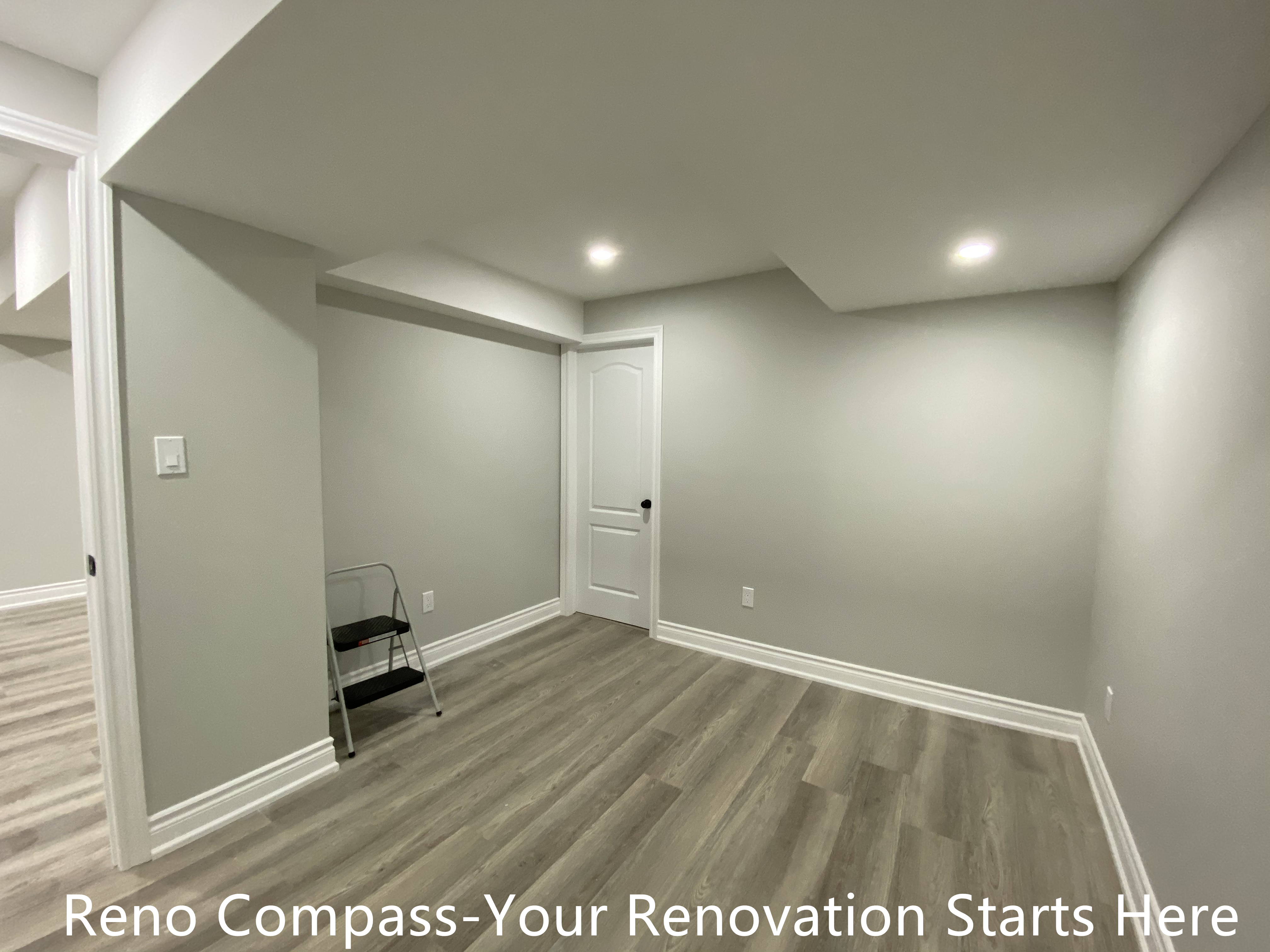 This Aurora basement renovation includes a newly finished multi-purpose room designed to adapt to various needs such as a home office, guest room, or hobby space. The layout features clean wall lines, recessed ceiling lighting, and durable wood-look flooring to ensure long-term usability and comfort. Structural soffits are carefully integrated into the ceiling design to maintain a balanced visual proportion while maximizing headroom. Neutral finishes allow for easy customization, making this space a practical addition to a fully renovated basement completed by Reno Compass.