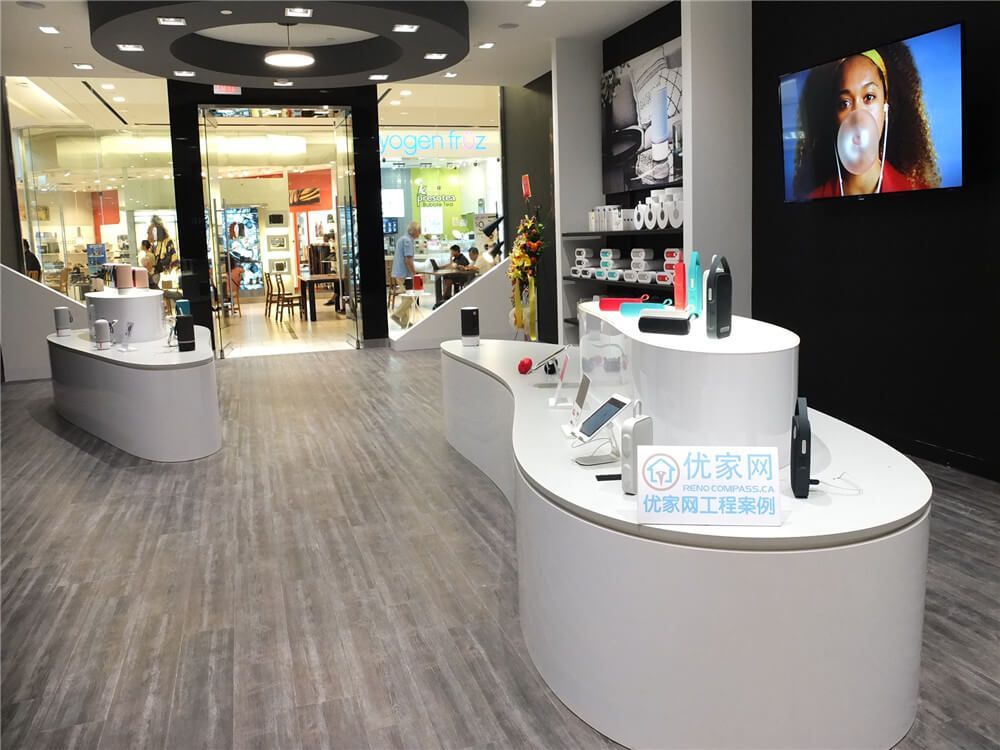 Retail store renovation project at Markville Mall featuring custom curved product display counters, durable commercial flooring, integrated ceiling lighting, and digital display screens. The modern retail interior layout enhances product visibility while maintaining a clean and spacious shopping environment. This commercial renovation demonstrates how thoughtful retail design and professional construction can improve customer experience in a busy Toronto shopping mall.