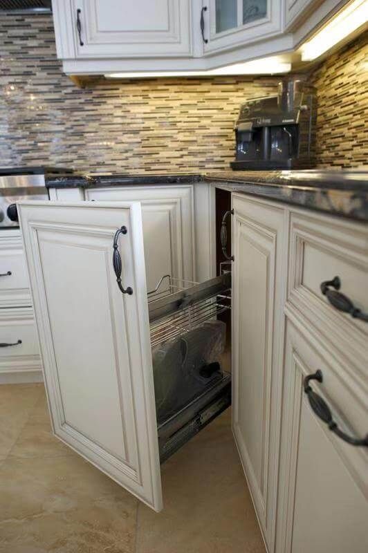 This European-style kitchen renovation highlights a smart pull-out corner cabinet system designed to maximize storage efficiency. The custom white cabinetry features classic panel detailing and elegant hardware, maintaining the project’s timeless aesthetic while integrating modern functionality.

The pull-out metal rack system allows easy access to corner storage, eliminating wasted space and improving everyday usability. Paired with a textured stone backsplash and under-cabinet lighting, the design combines practicality with upscale craftsmanship.

This detail reflects thoughtful kitchen planning, ideal for homeowners seeking a luxury kitchen renovation that enhances both organization and convenience without compromising style.