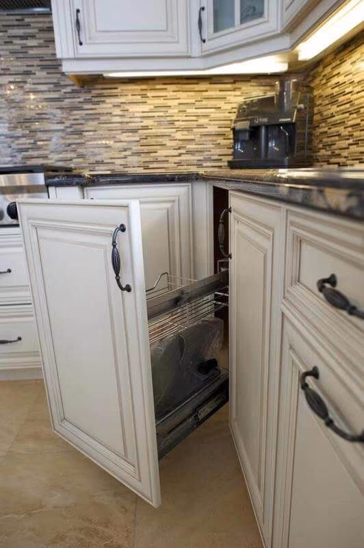 This European-style kitchen renovation highlights a smart pull-out corner cabinet system designed to maximize storage efficiency. The custom white cabinetry features classic panel detailing and elegant hardware, maintaining the project’s timeless aesthetic while integrating modern functionality.

The pull-out metal rack system allows easy access to corner storage, eliminating wasted space and improving everyday usability. Paired with a textured stone backsplash and under-cabinet lighting, the design combines practicality with upscale craftsmanship.

This detail reflects thoughtful kitchen planning, ideal for homeowners seeking a luxury kitchen renovation that enhances both organization and convenience without compromising style.