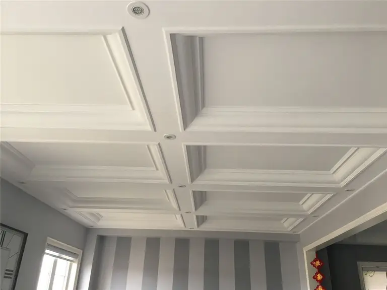 Custom coffered ceiling with recessed lighting installed as part of a Toronto interior renovation project. The detailed ceiling trim and structured panel design add depth, elegance, and architectural character to the living space, completed by a professional Toronto renovation company.