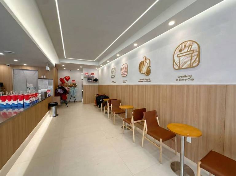 This newly renovated bubble tea shop in North York features a modern seating area with custom wall paneling, warm lighting design, and optimized customer flow. Completed by a professional Toronto renovation company, the commercial space combines clean aesthetics with functional layout, creating a comfortable and stylish environment for customers to relax and enjoy their drinks.
