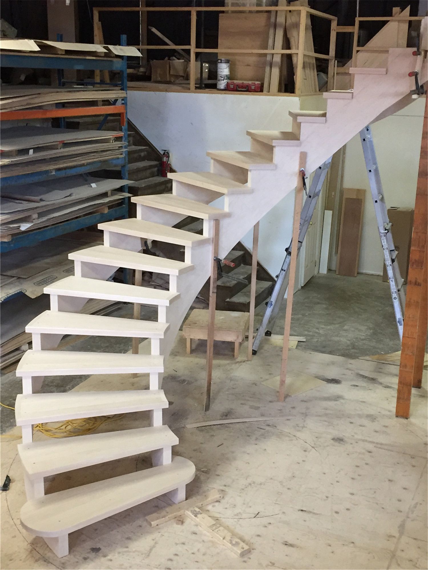 This image showcases a custom curved staircase under construction as part of a Toronto stair renovation project. The staircase features precisely crafted hardwood treads and a smooth curved structure designed for both durability and architectural elegance. Professional framing and careful step alignment ensure structural stability and a refined finish. As an experienced Toronto Renovation Company, Reno Compass Inc. delivers high-quality staircase renovation solutions that enhance both safety and interior aesthetics for homes across the Greater Toronto Area.