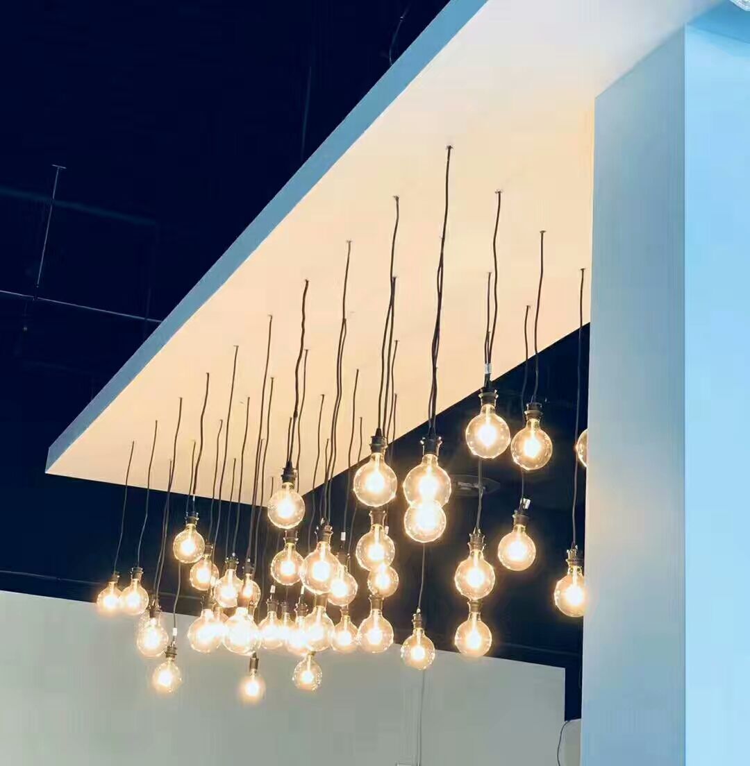 Modern hanging bulb lighting installed in a North York commercial renovation project. The suspended pendant lights create a warm and stylish atmosphere, enhancing the interior design of a restaurant or entertainment venue while providing soft ambient lighting for customers.