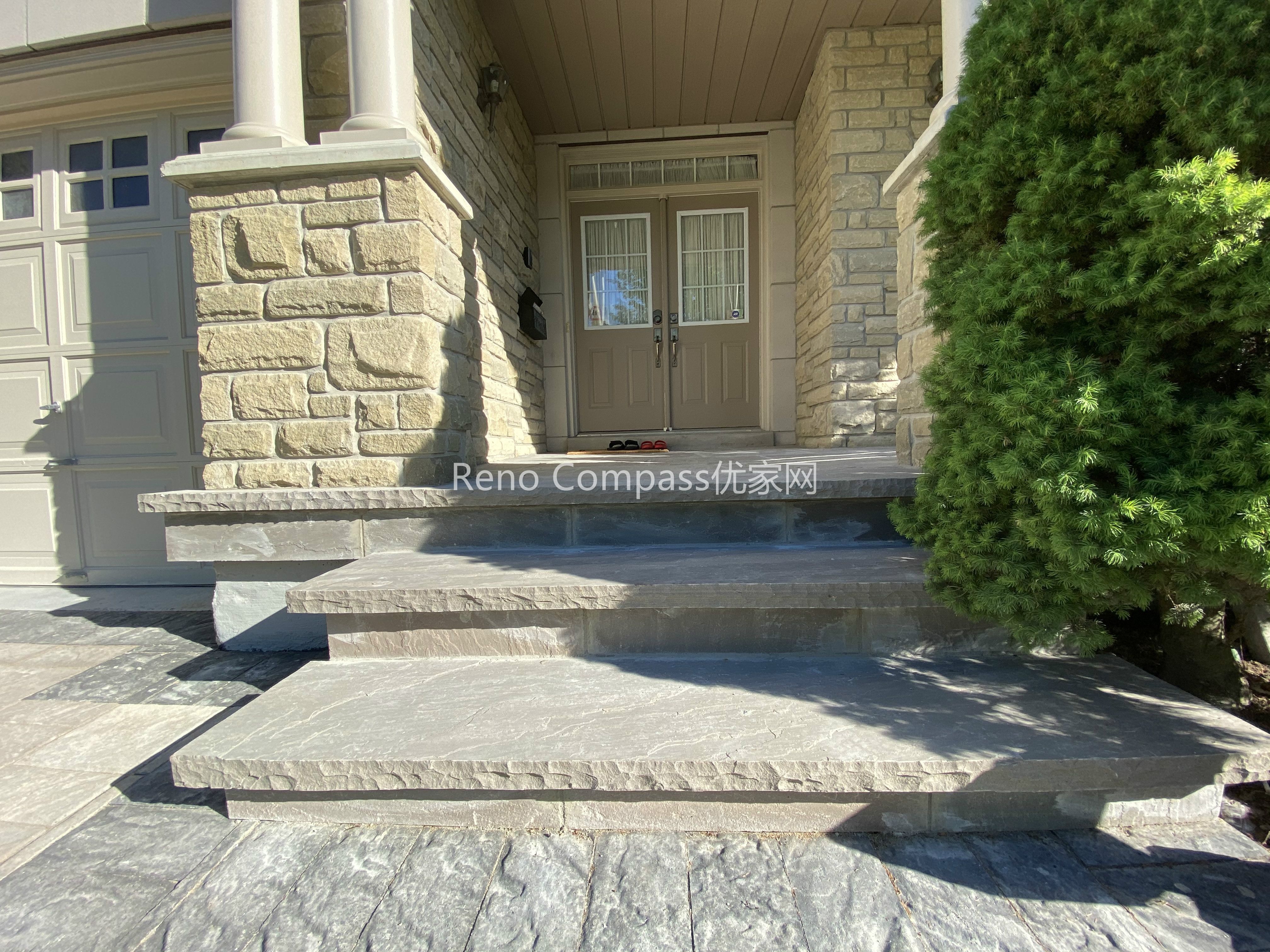 This image showcases the natural stone front entrance steps completed as part of a North York driveway interlocking project. Large-format stone slabs are carefully installed to create solid, level steps that provide safe and comfortable access to the home’s main entrance. The stone steps integrate seamlessly with the home’s stone façade and surrounding interlocking surfaces, ensuring visual continuity and structural stability. Designed for durability and year-round use, these entrance steps enhance curb appeal while maintaining proper rise, tread depth, and drainage. Completed by a Toronto interlocking and landscaping contractor, this project reflects precision craftsmanship and attention to exterior detailing.