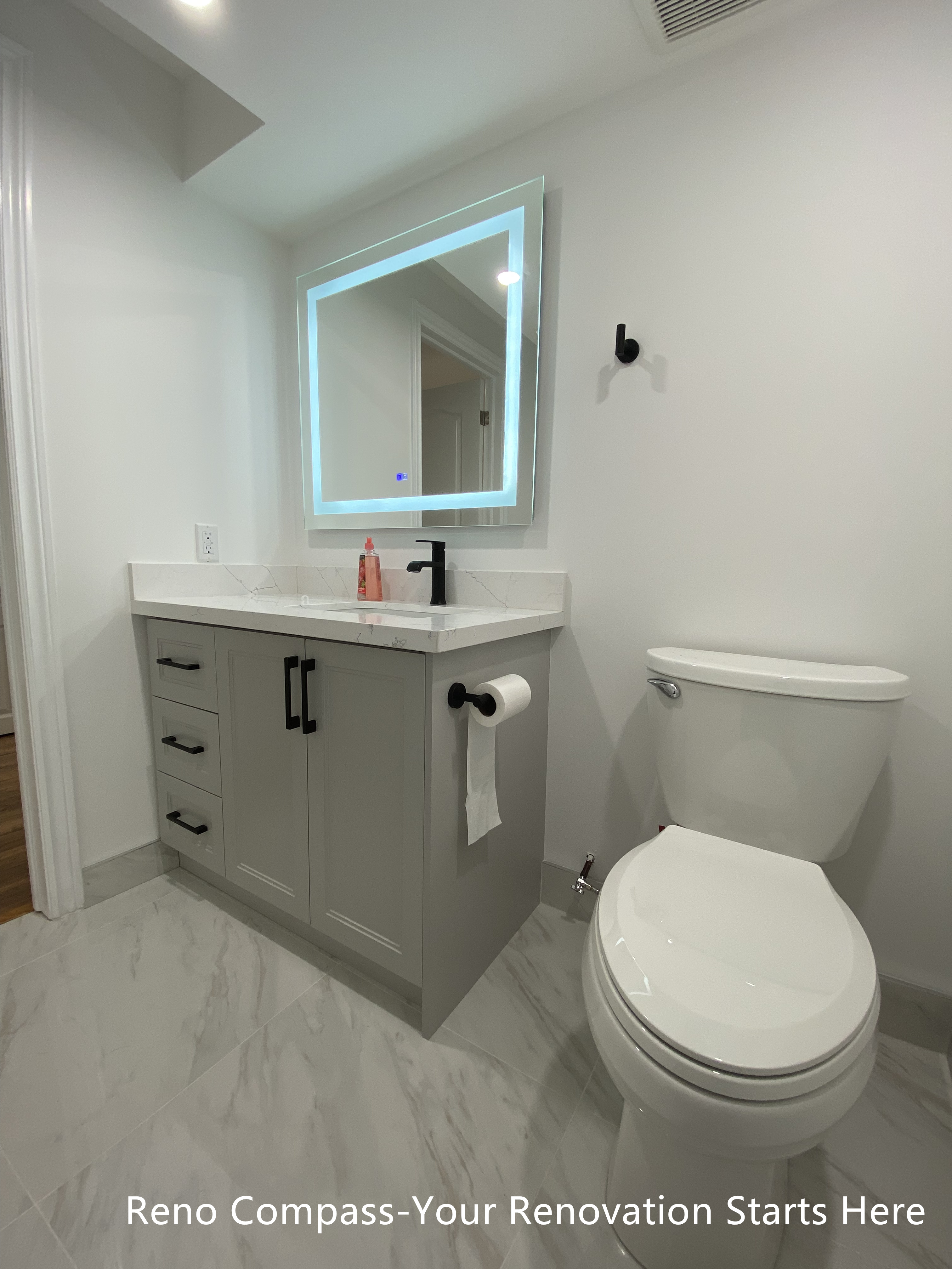 This Bradford basement bathroom renovation features a modern floating vanity, quartz countertop, matte black fixtures, and large-format tile flooring. Designed for durability and easy maintenance, this space enhances everyday functionality while maintaining a clean, contemporary look as part of a full basement renovation by a Toronto renovation company.