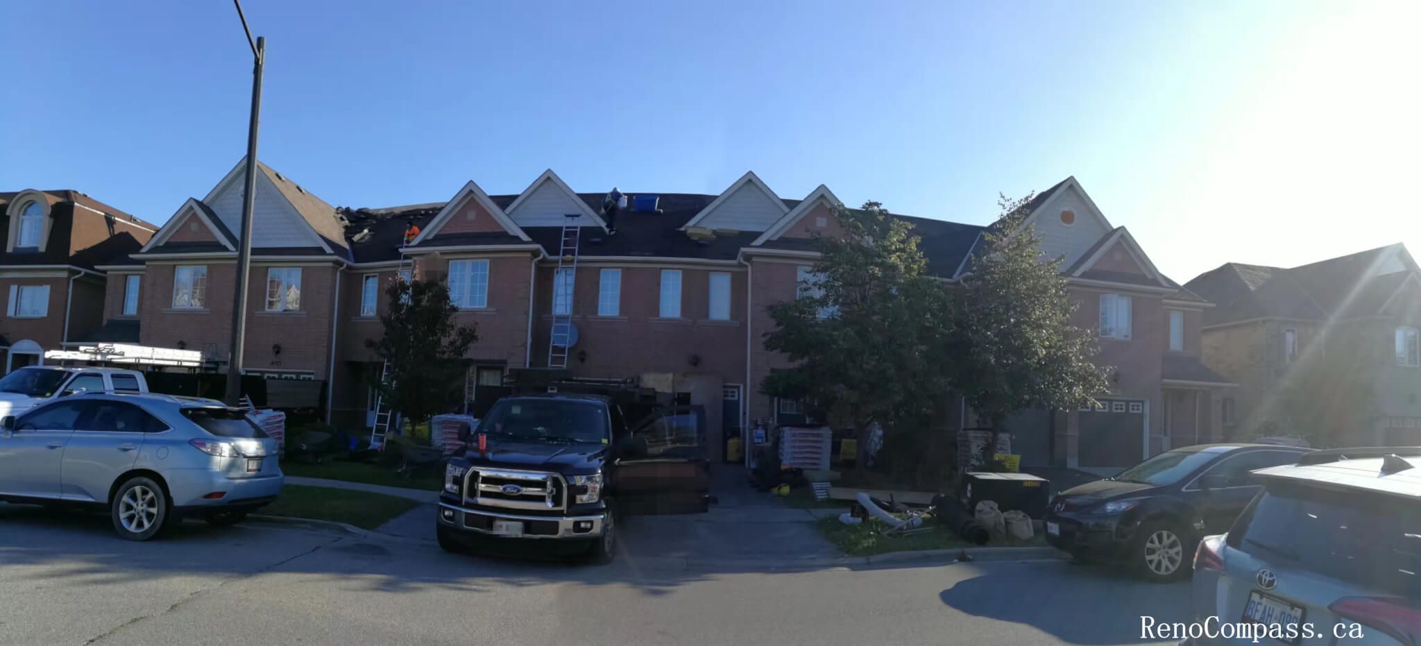 Full roof replacement in progress on a large brick corner-lot home in Markham. Our professional team utilizes high-reach ladders and specialized disposal trucks to ensure a clean, safe, and efficient shingle installation process.