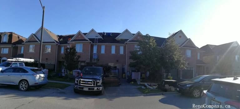 Full roof replacement in progress on a large brick corner-lot home in Markham. Our professional team utilizes high-reach ladders and specialized disposal trucks to ensure a clean, safe, and efficient shingle installation process.