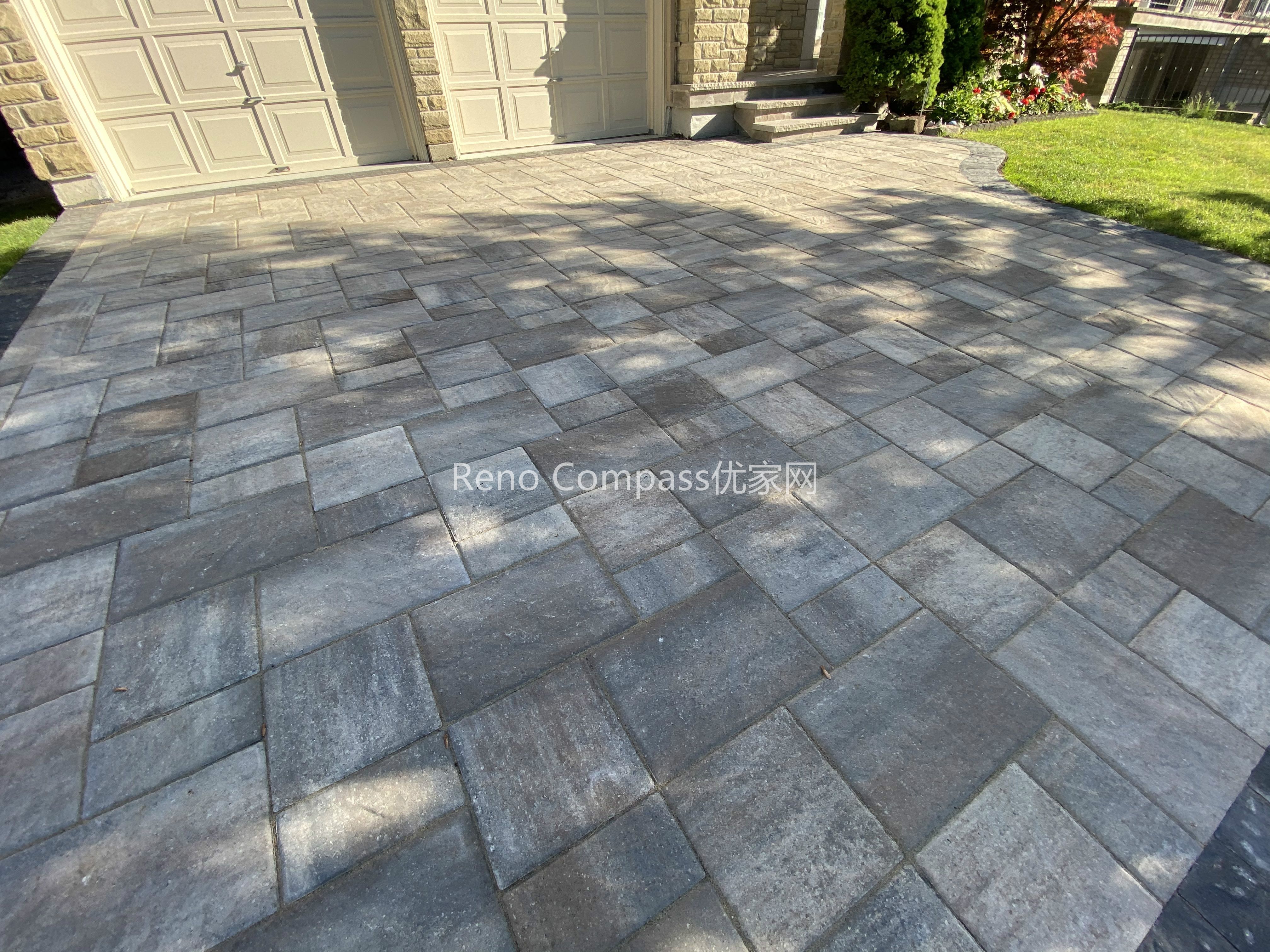 This image highlights the detailed interlocking pattern of a natural stone driveway in North York. The rectangular stone pavers are carefully aligned to create a clean, structured layout that enhances surface stability and visual consistency. Subtle color variation in the natural stone adds depth while maintaining a cohesive appearance across the driveway. Designed for durability and proper load distribution, this interlocking driveway supports everyday vehicle use and long-term performance. Completed by a Toronto interlocking and landscaping contractor, this project reflects precise installation standards and attention to paving detail.